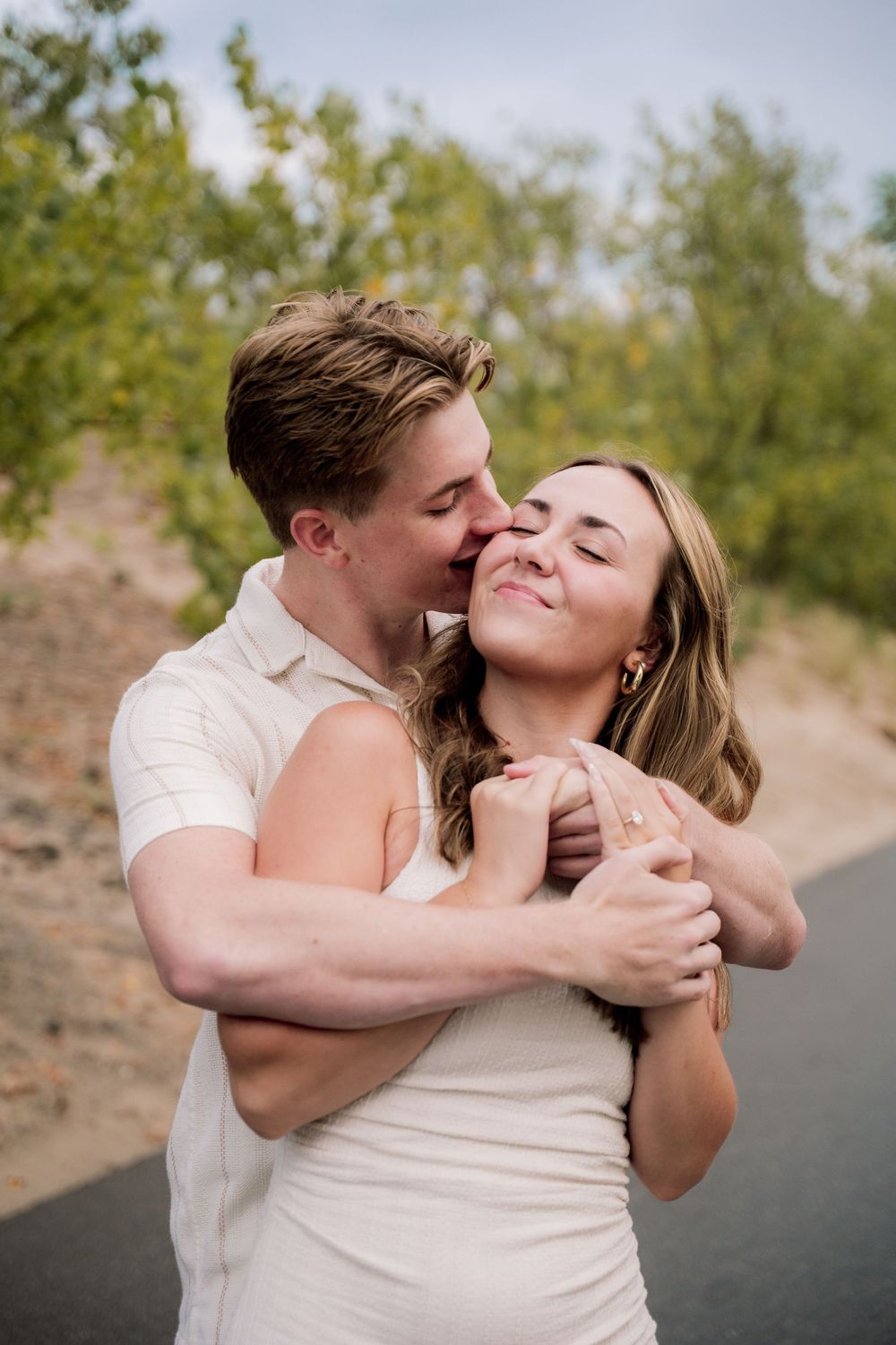 A romantic couple shares tender kisses and embraces in a series of candid outdoor photos.