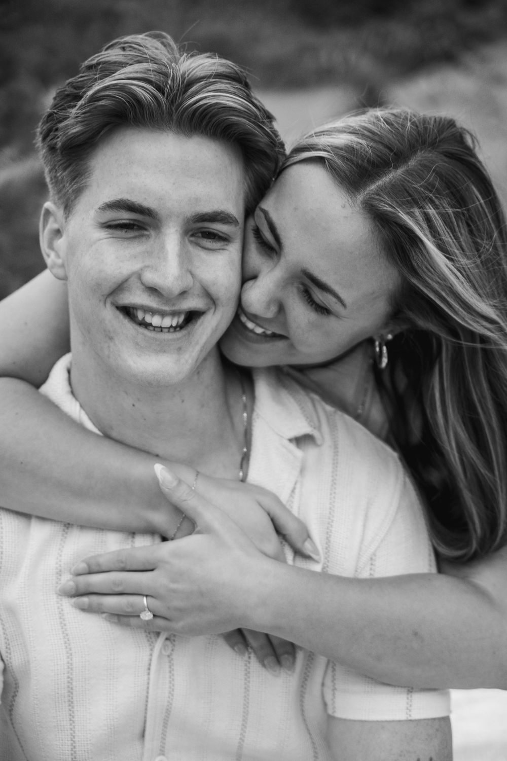 A romantic black and white photo series showing an intimate couple embracing and laughing together.