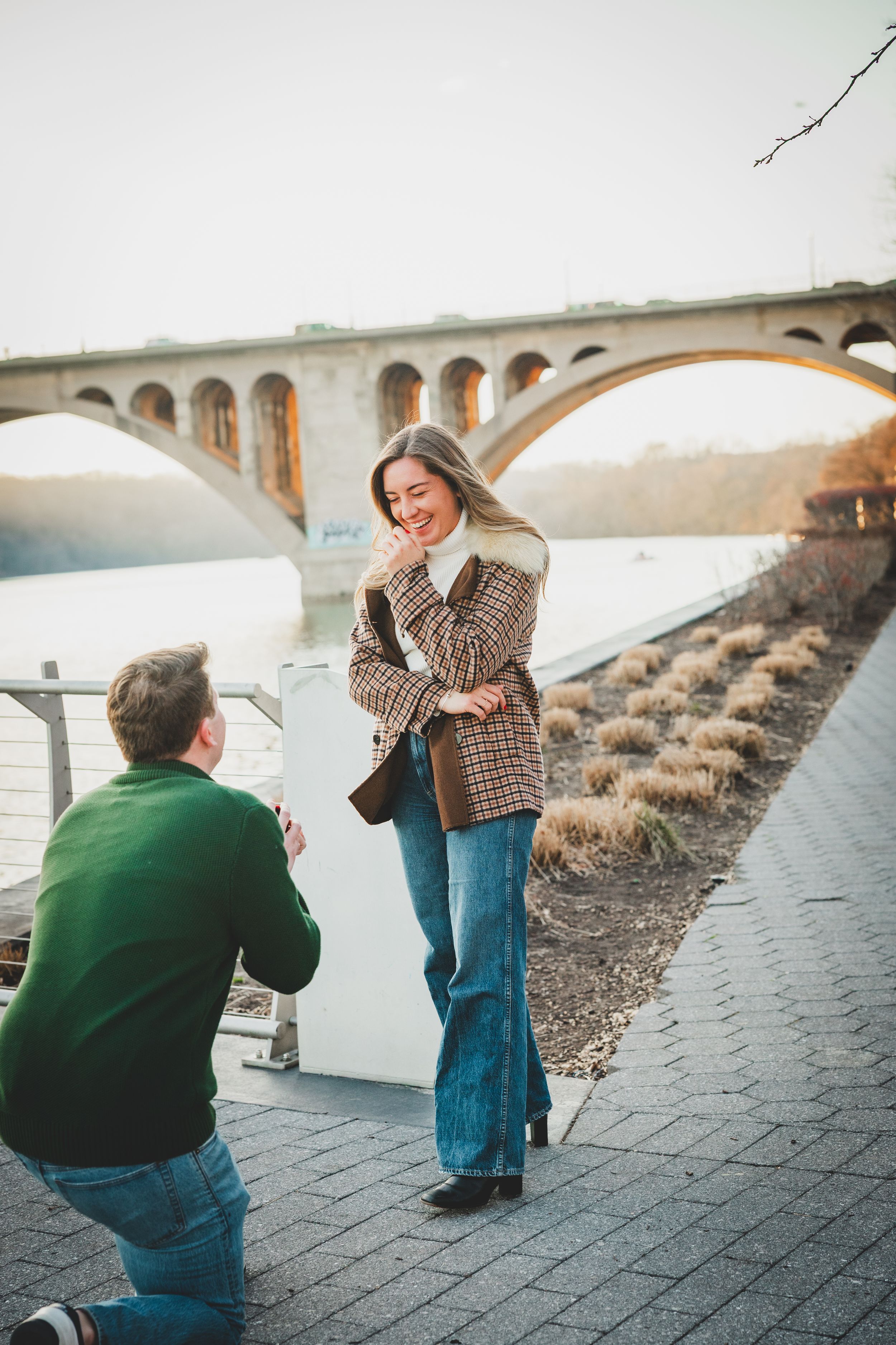 A man proposing to his girlfriend at the Georgetown waterfront, one of the best locations for dc proposal