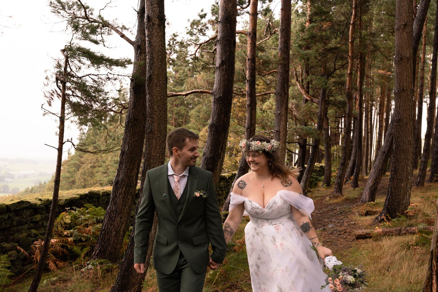 A bride and groom share intimate moments in a scenic forest setting with tall pine trees and natural lighting.