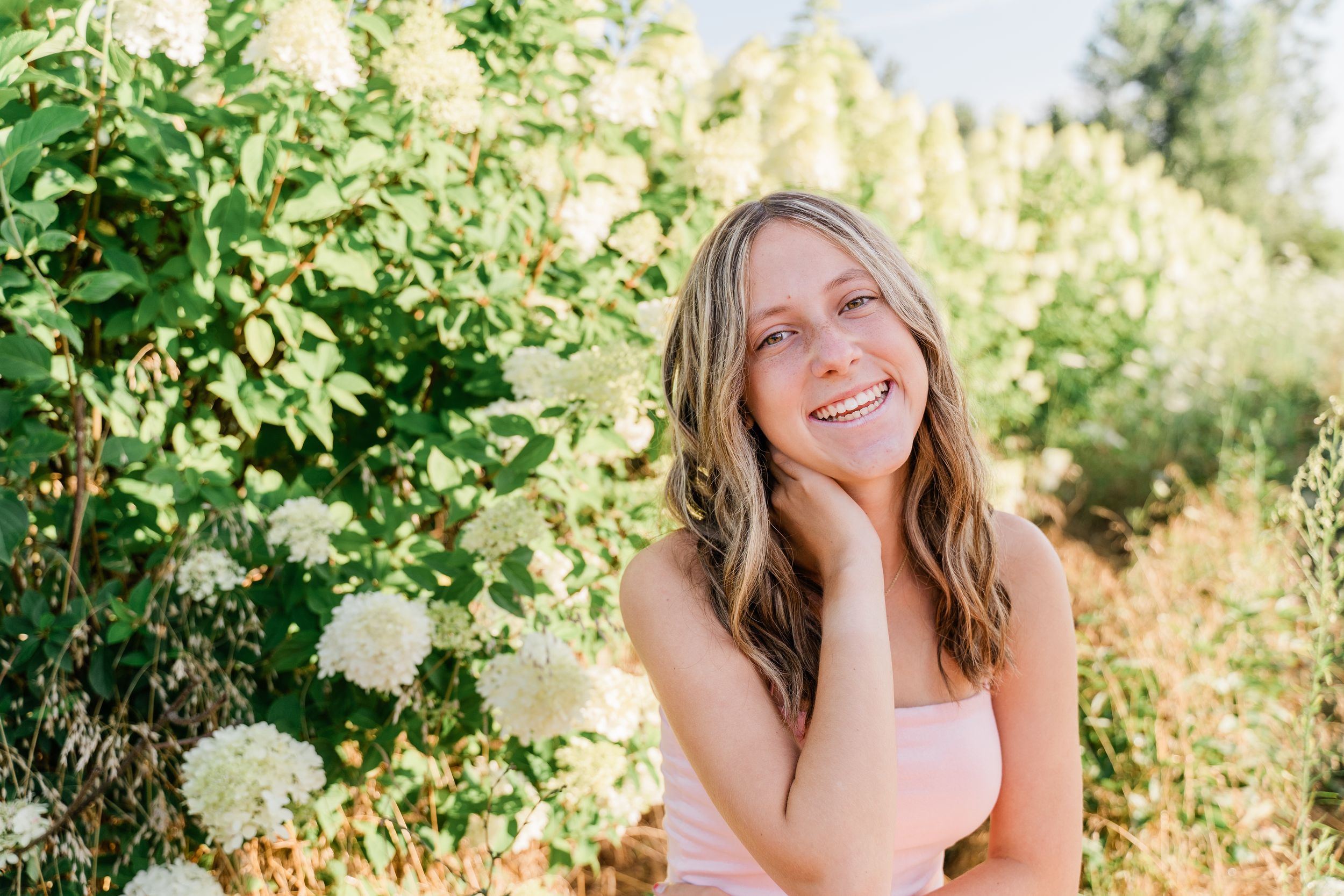 A series of outdoor portrait photos taken in golden sunlight with green foliage and natural backdrops.