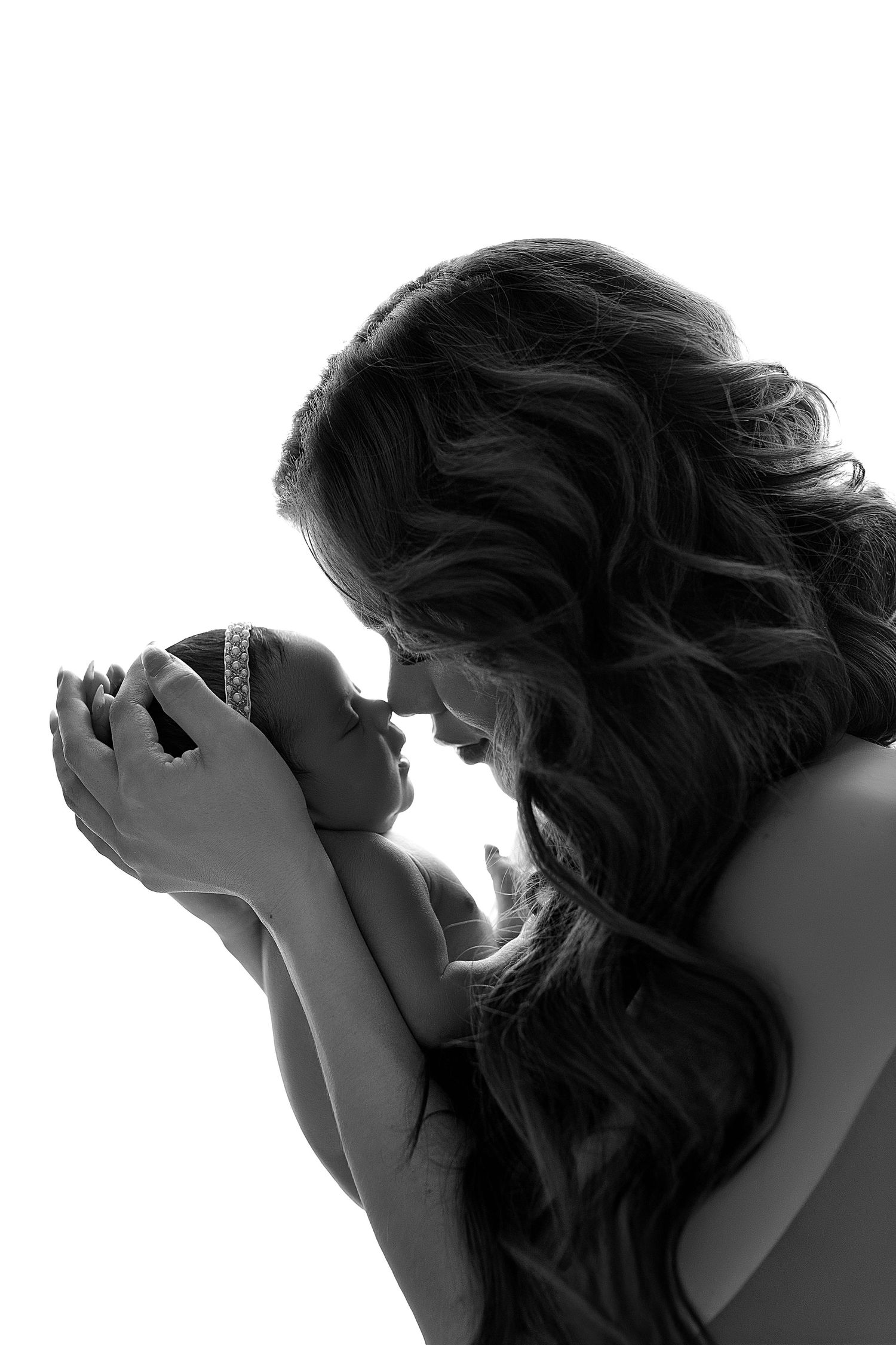 A black and white photo series showing a person with flowing hair holding their head in various emotional poses.