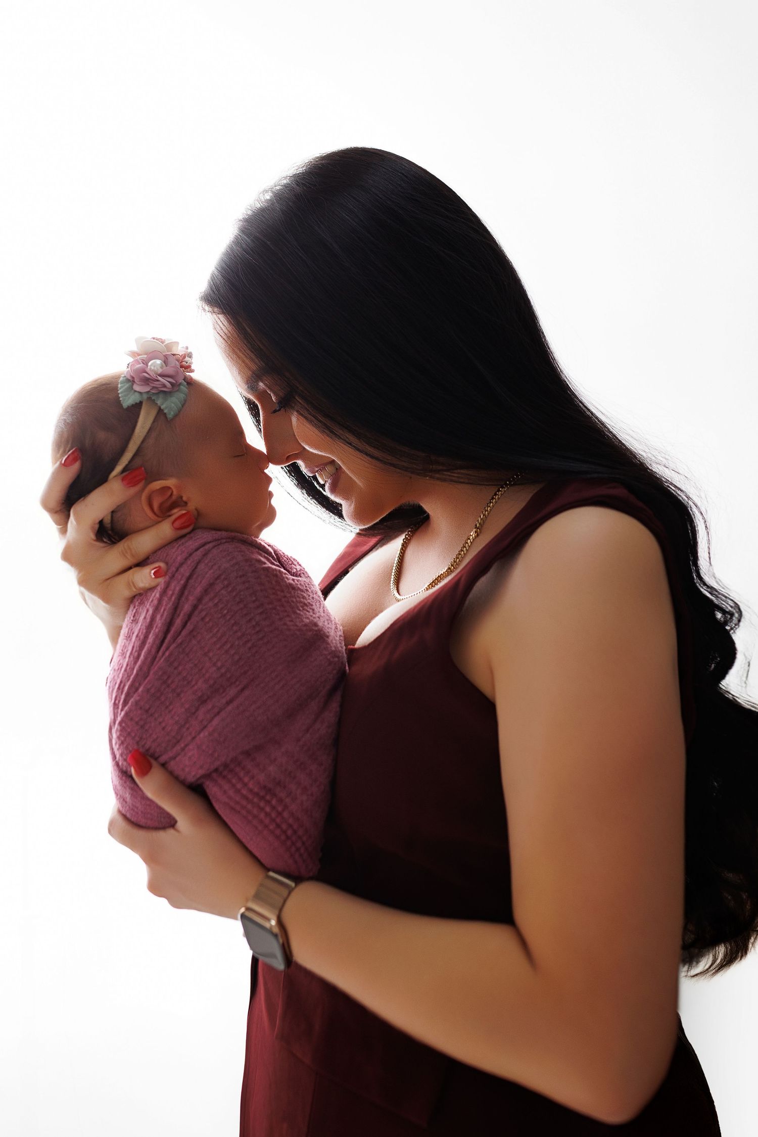 A tender moment between parent and baby in silhouette against white background shown in three sequential poses.