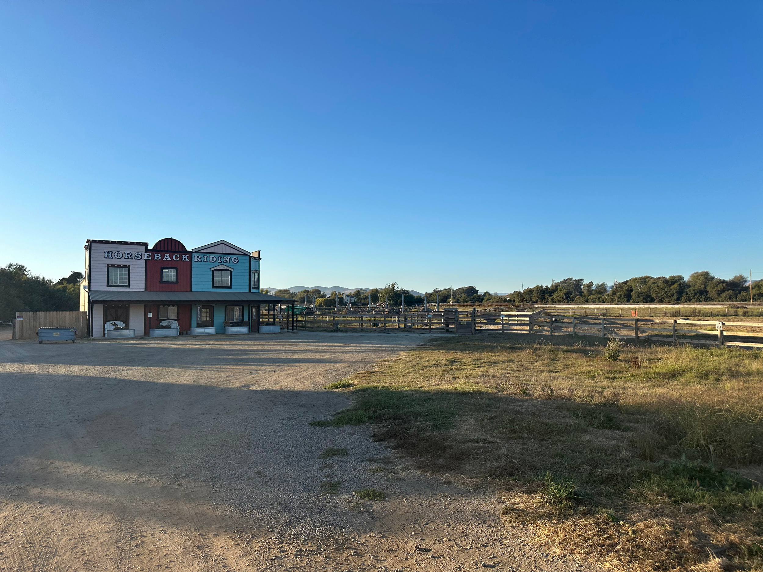 A series of photos showing commercial properties and empty lots along a rural road with blue skies overhead.