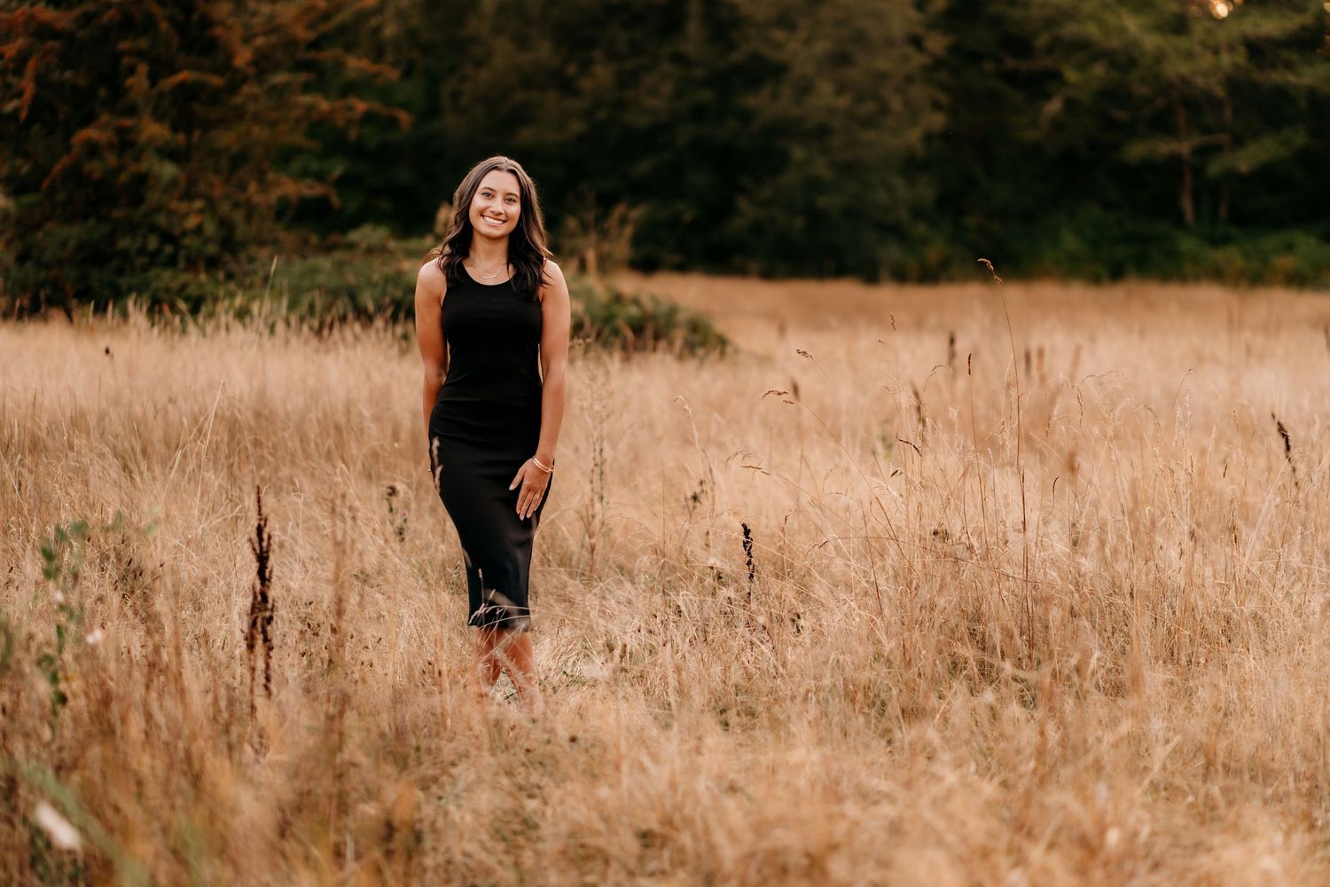 Outdoor high school senior photo shot during summer for golden glow in a wheat field.