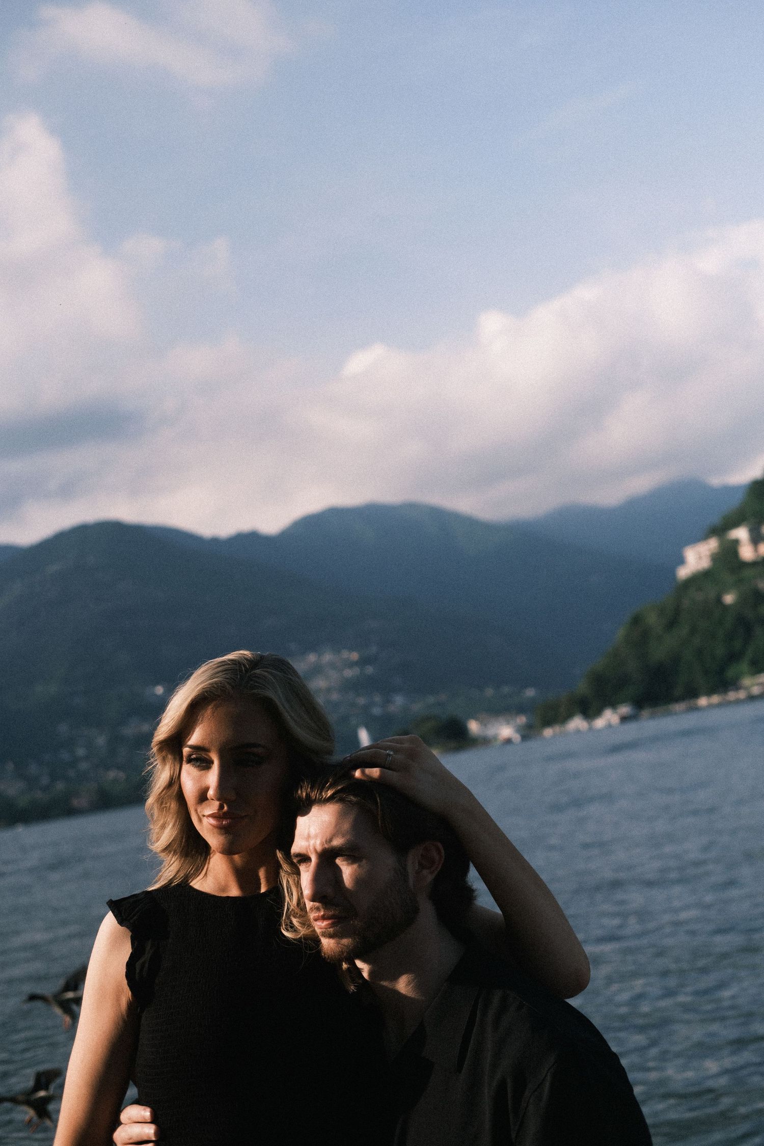 Romantic couple hug Lake Como sunset mountains