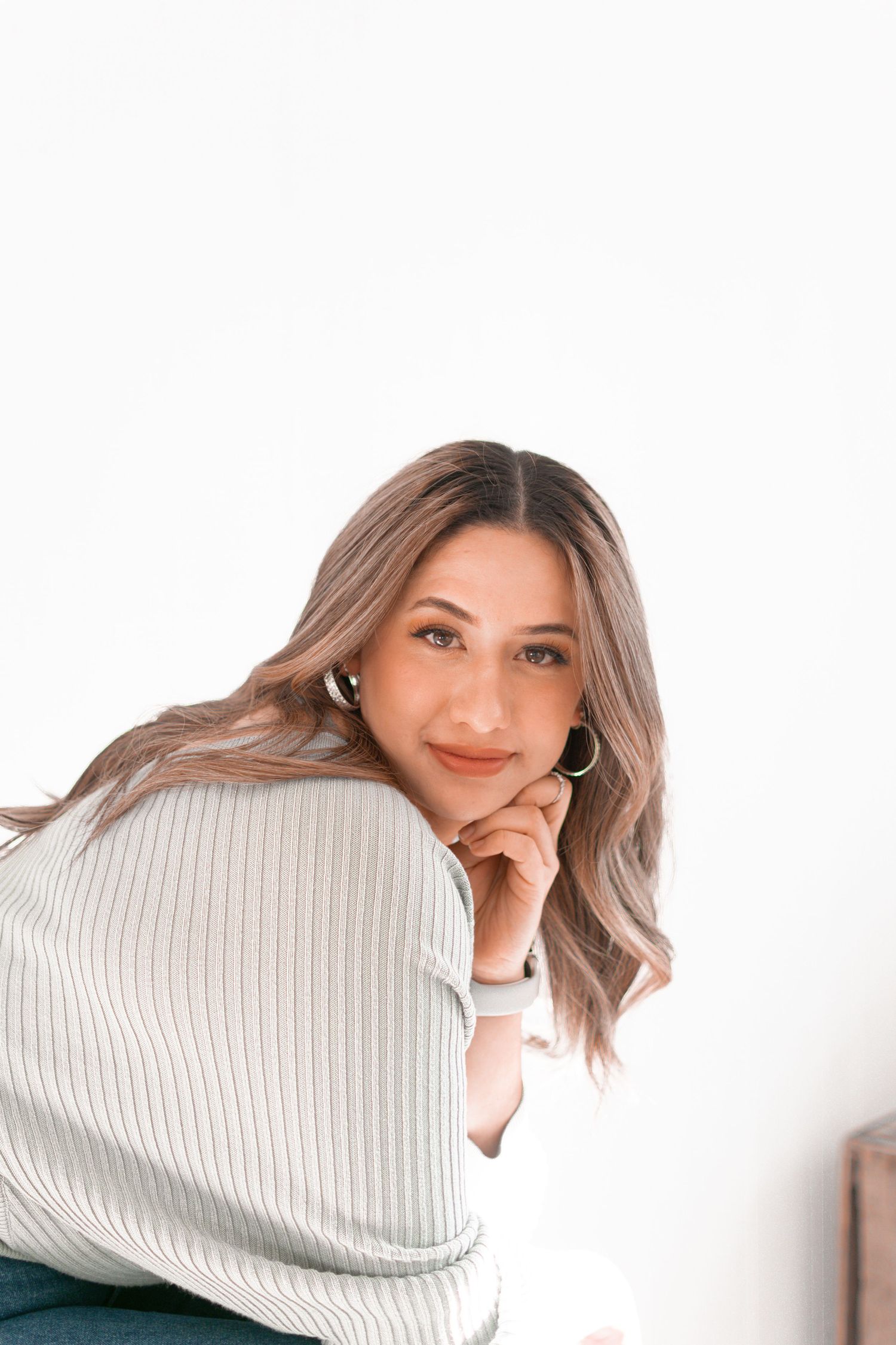 A series of photos showing someone wearing a white turtleneck sweater while posing playfully against a white background.