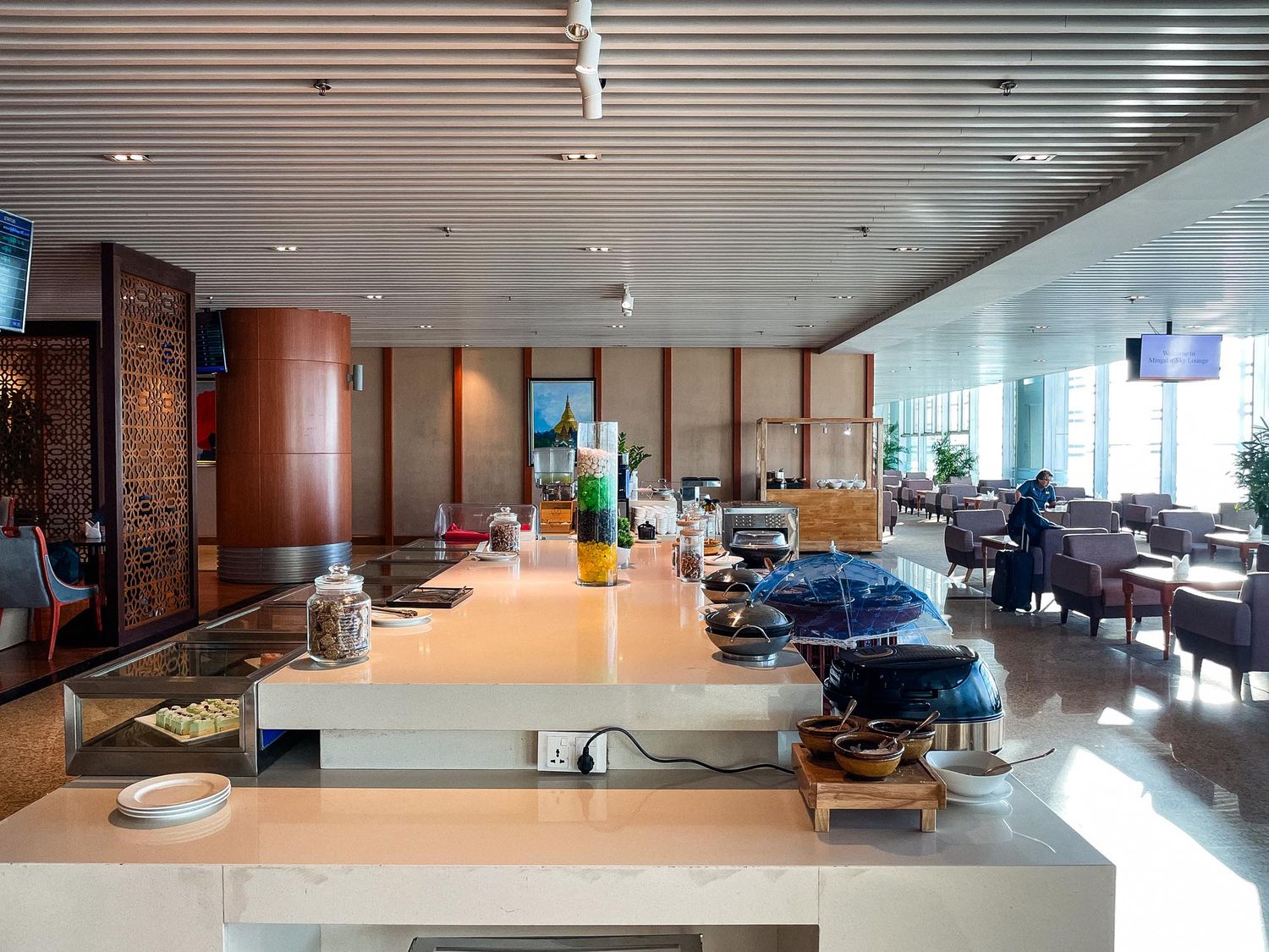 Modern office interior with sleek wooden panels and recessed lighting creates a professional workspace environment.