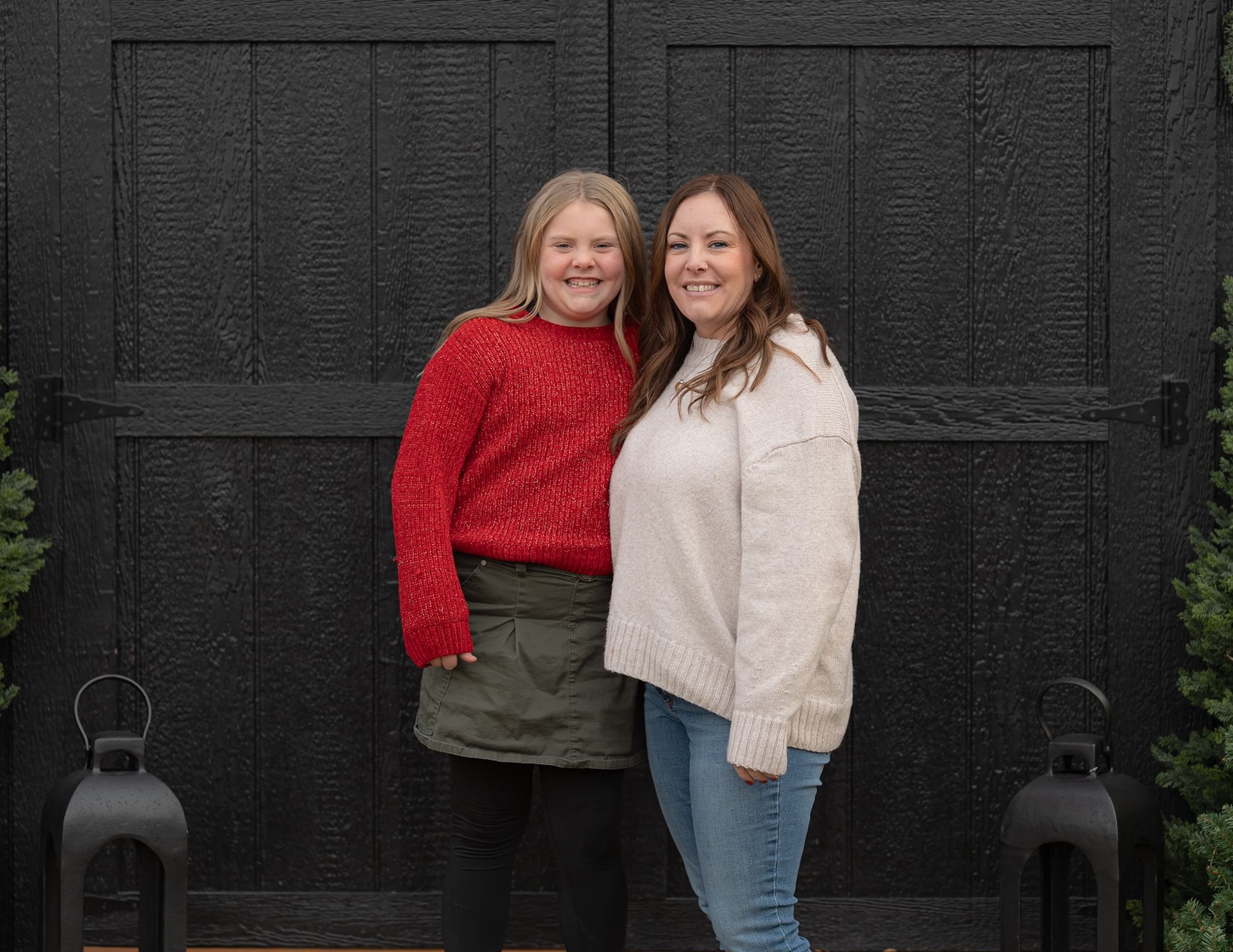 A series of casual portraits against a black wall showing different poses.