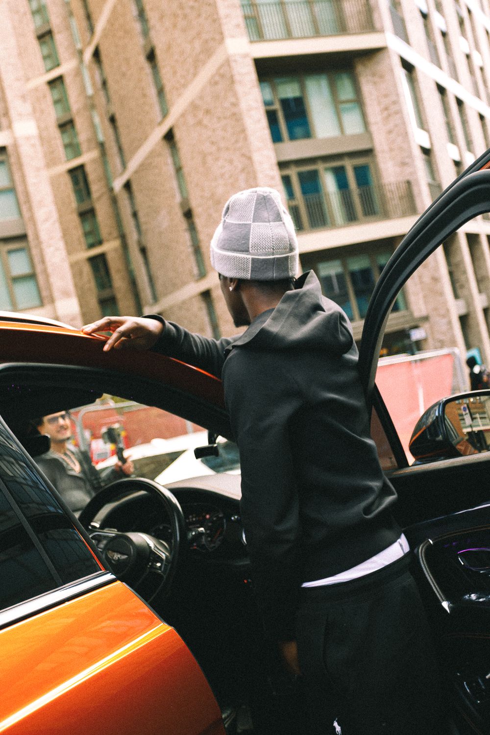A sequence of shots showing someone exiting a yellow taxi cab in an urban setting.