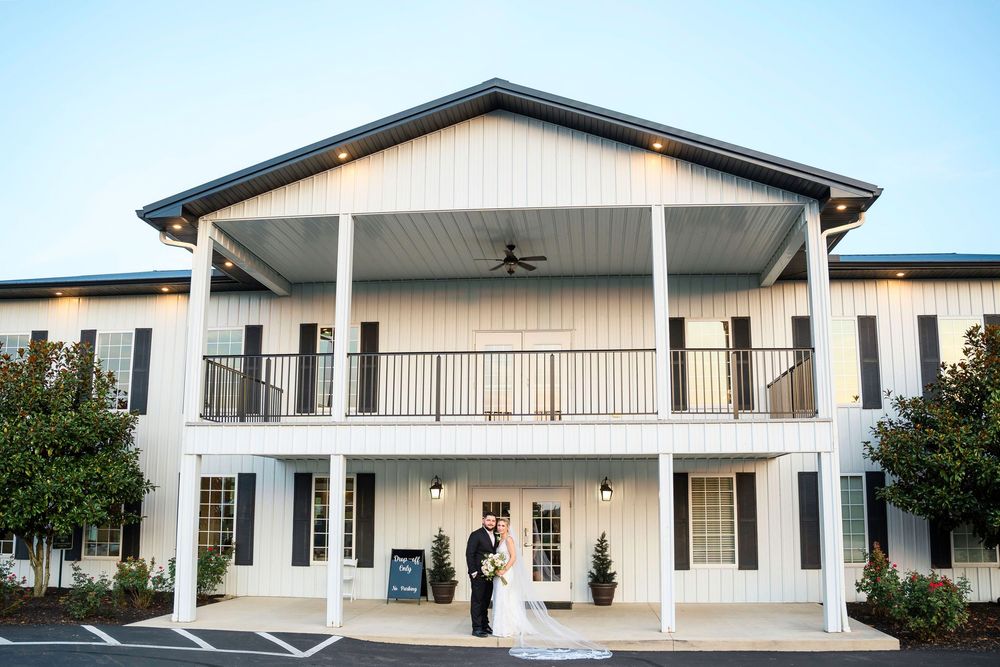 Bride and Groom getting couple's portraits in front of their venue at The Magnolia Estate Rosewood Manor: Cincinnati wedding photographer