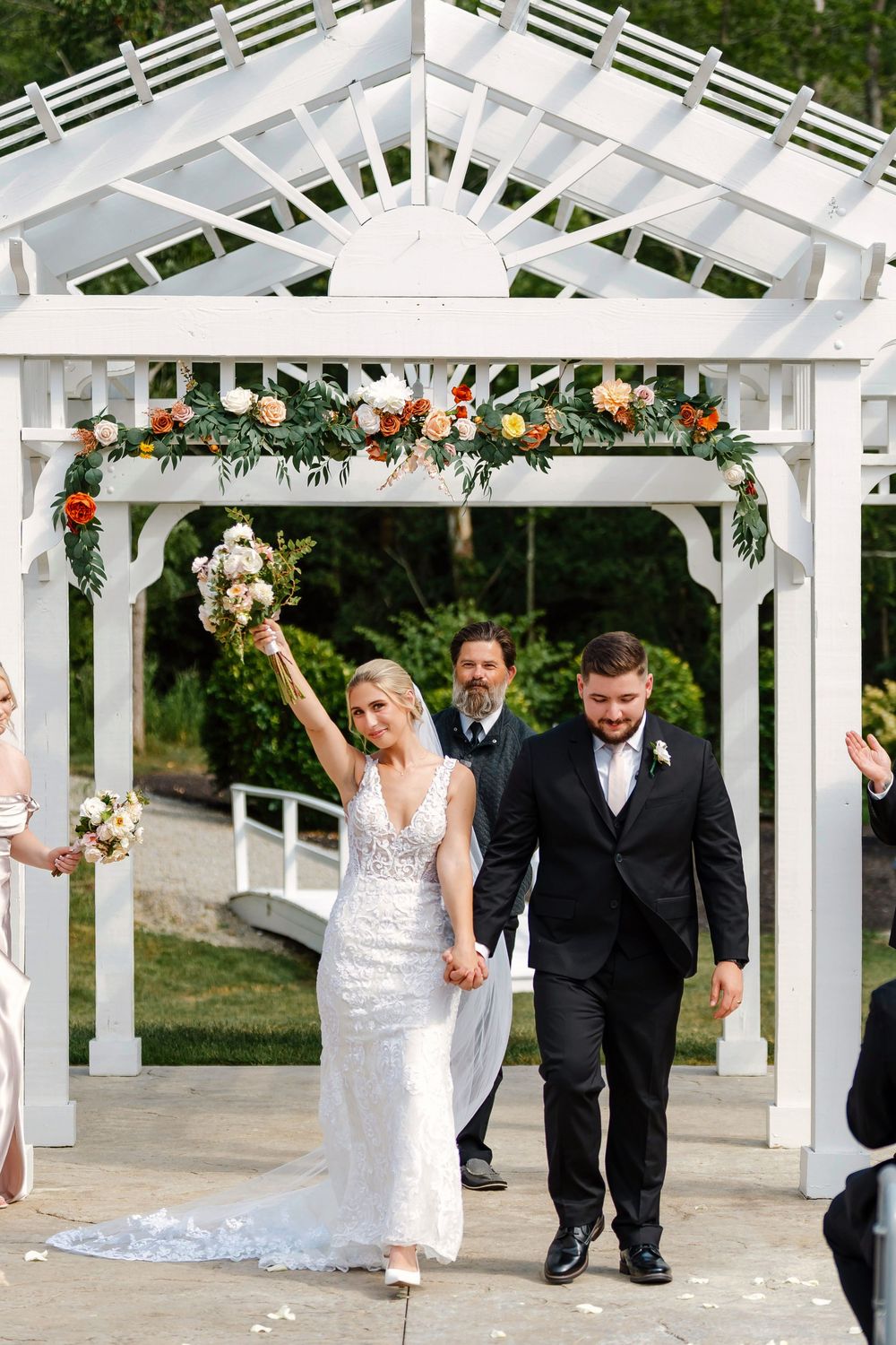 Bride and groom walking down the aisle cheering after the ceremony at The Magnolia Estate Rosewood Manor: Cincinnati wedding photographer