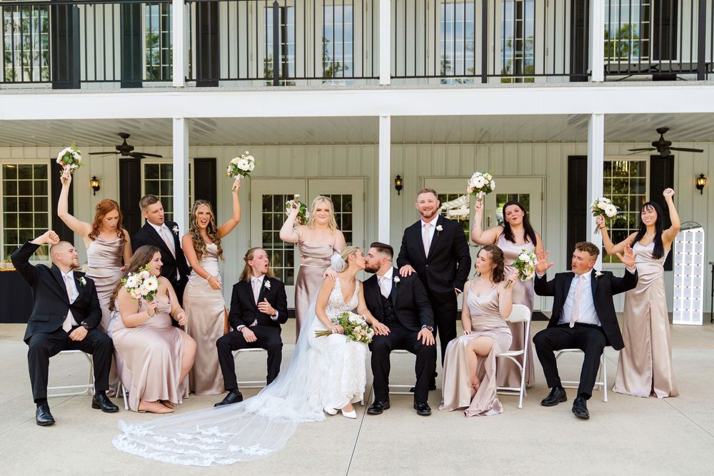Bridal Party cheering while the bride and groom kiss at The Magnolia Estate Rosewood Manor Miamisburg Ohio Cincinnati wedding photographer