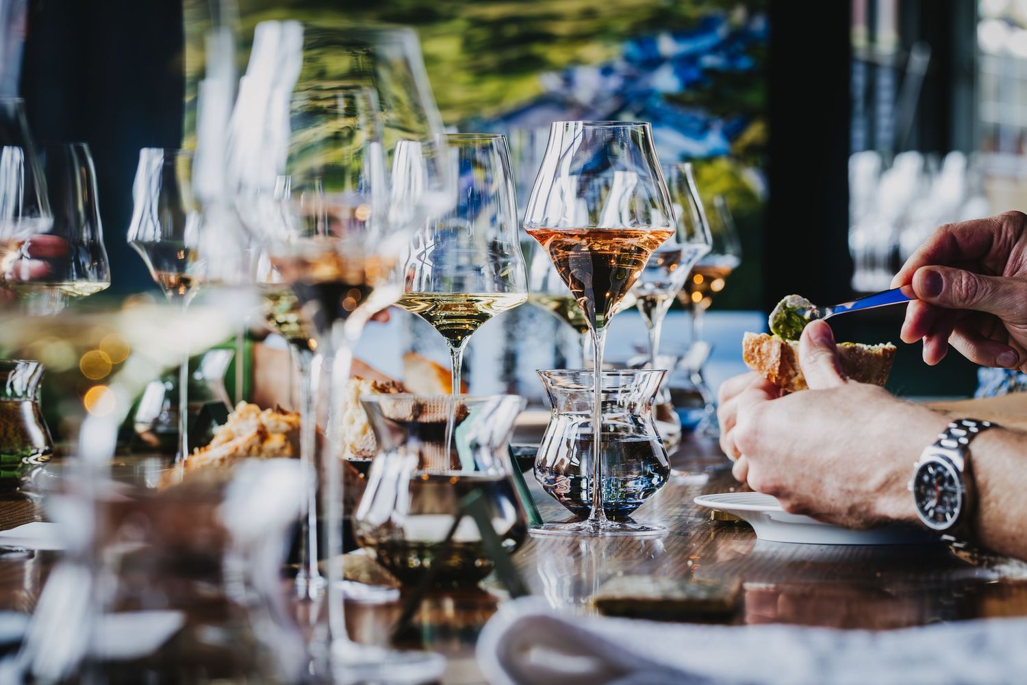 Collection of wine glasses arranged on a table with soft focus lighting.