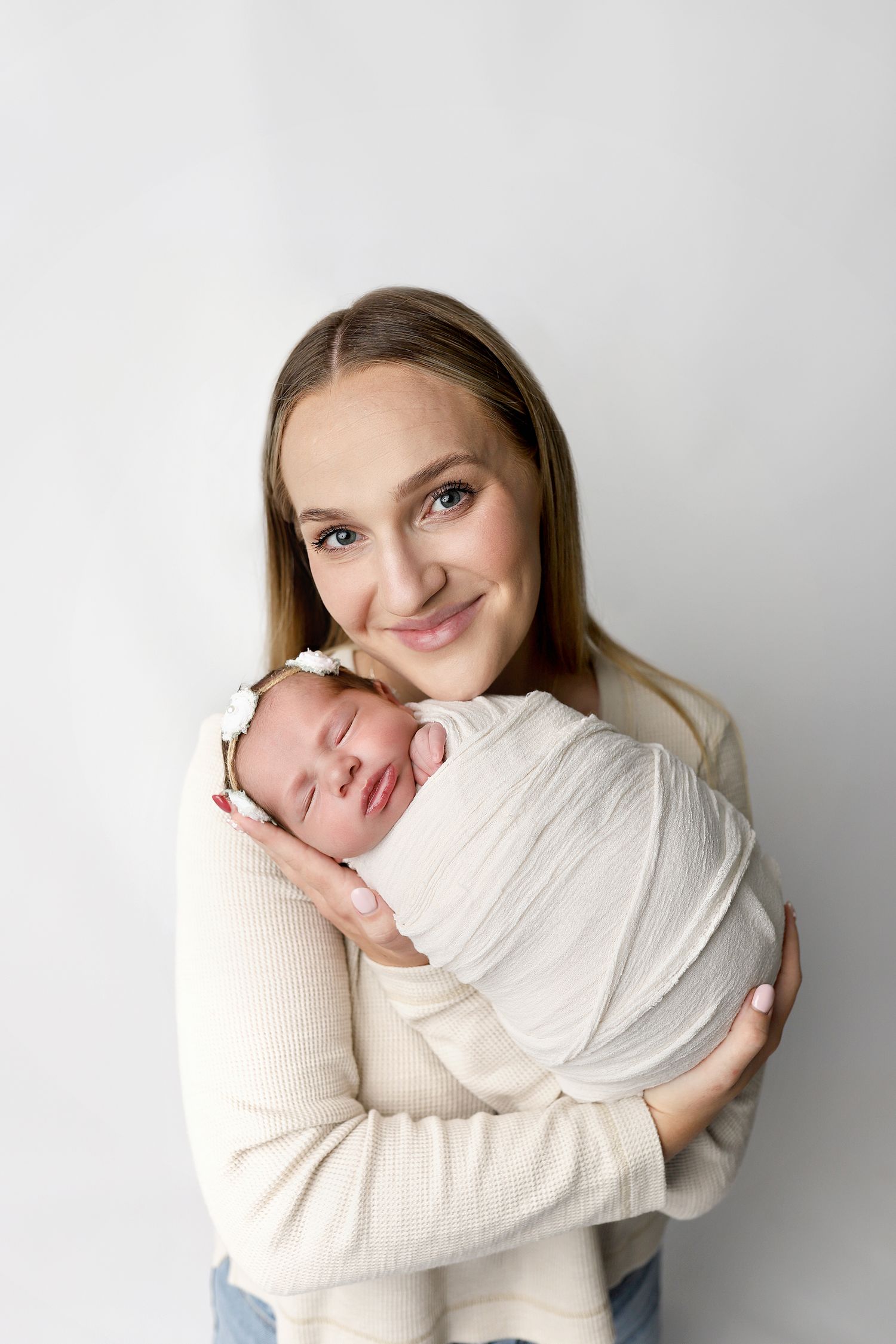 A tender embrace captured in a series of three intimate portraits against a light gray background.