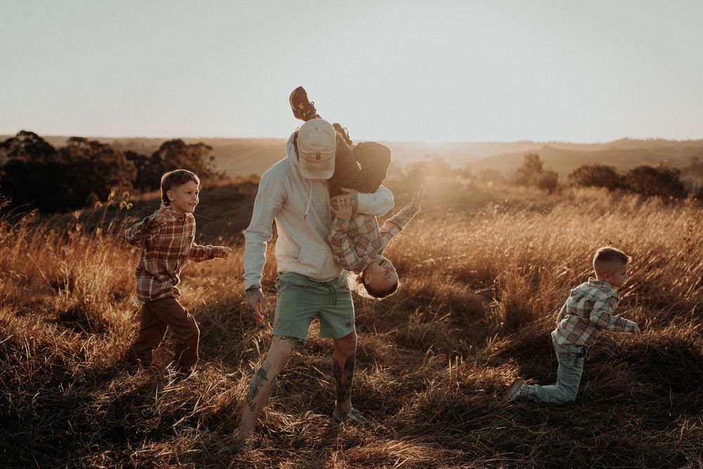 Family playing together in a field in Picton NSW