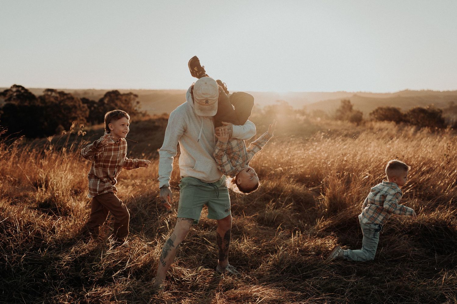 Family playing together in a field in Picton NSW