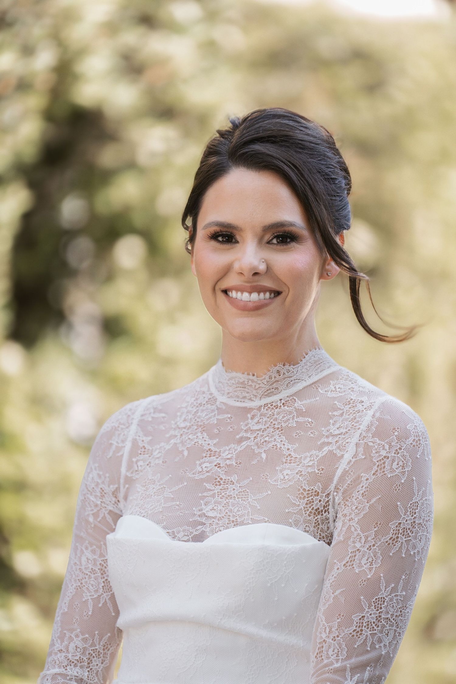 Close-up view of delicate white lace details on a wedding dress with intricate beading patterns.