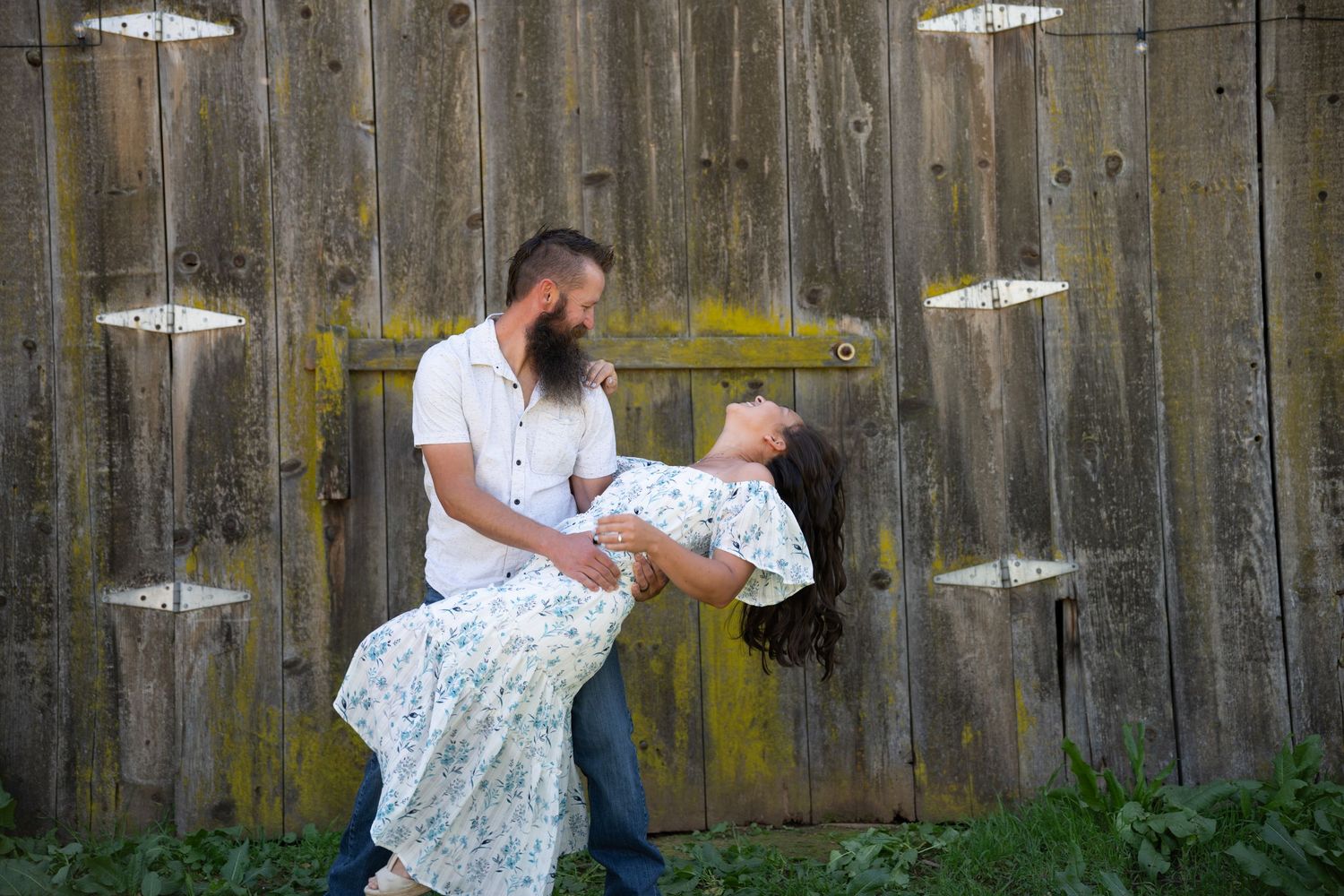 A sequence of four connected photos showing a couple dancing together in front of a wooden fence.