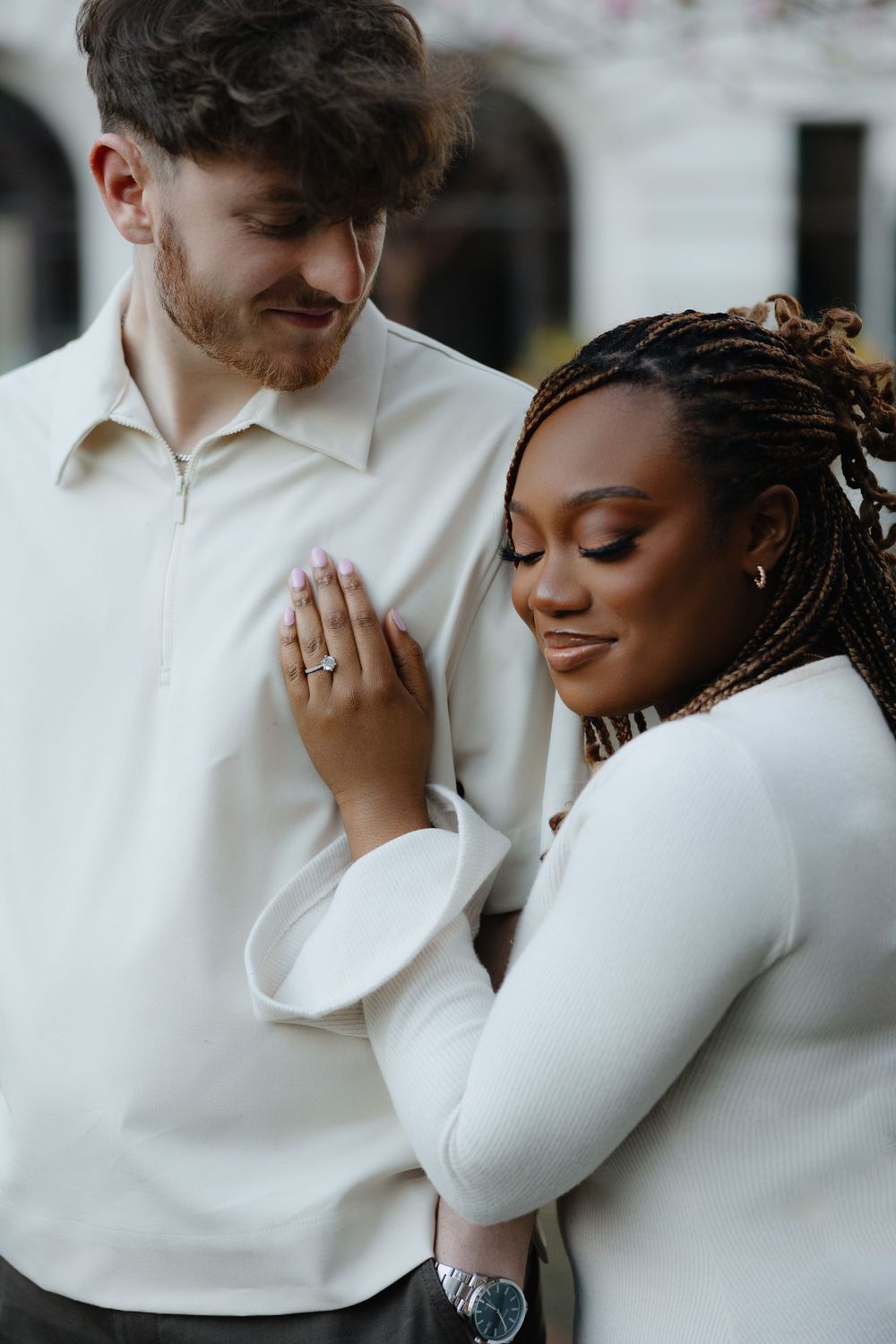 An intimate couple in white clothing shares tender moments in a romantic photoshoot series.