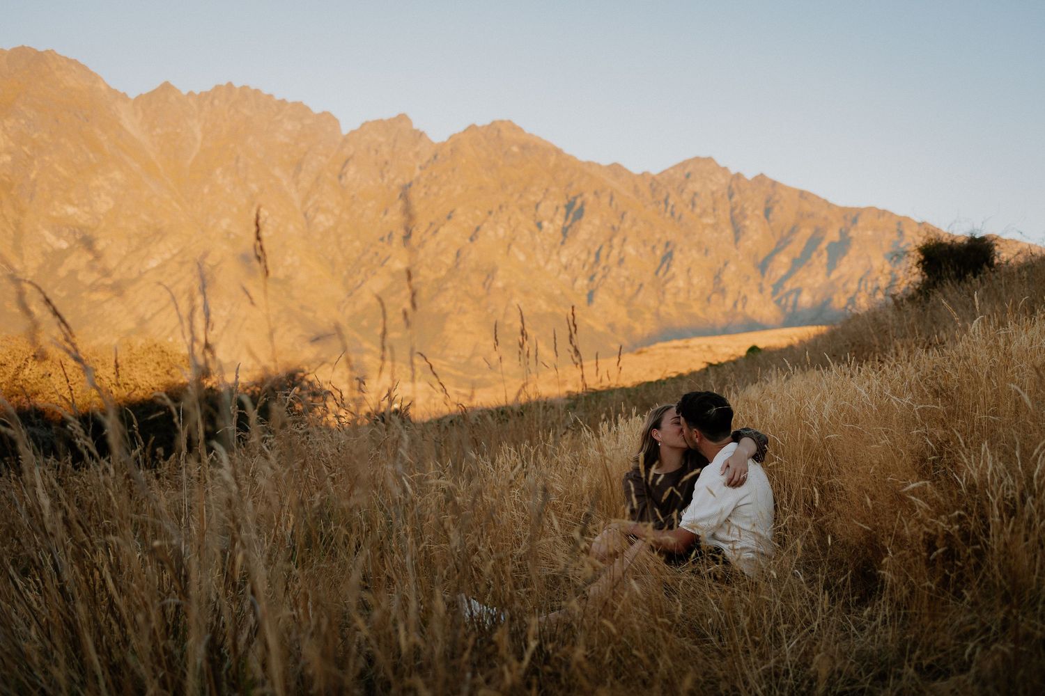A series of panoramic mountain landscape photos showing rugged peaks bathed in golden sunset light.