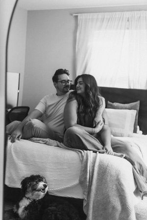 Black and white photos of two people relaxing together on a couch with a dog.