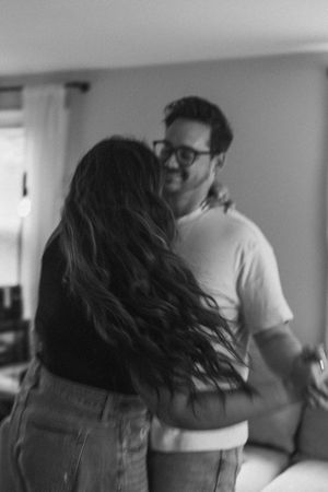 Black and white photo series showing a tender moment between two people on a couch.