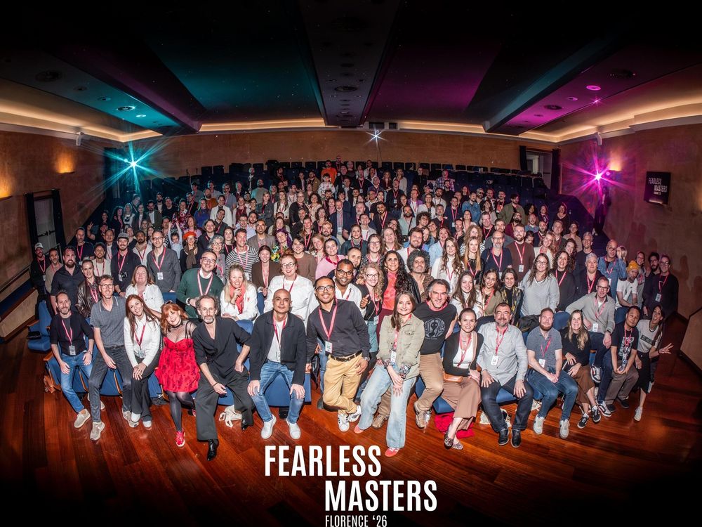 Large group photo at Fearless Masters Florence 2019 event, with attendees posing in a theater venue.