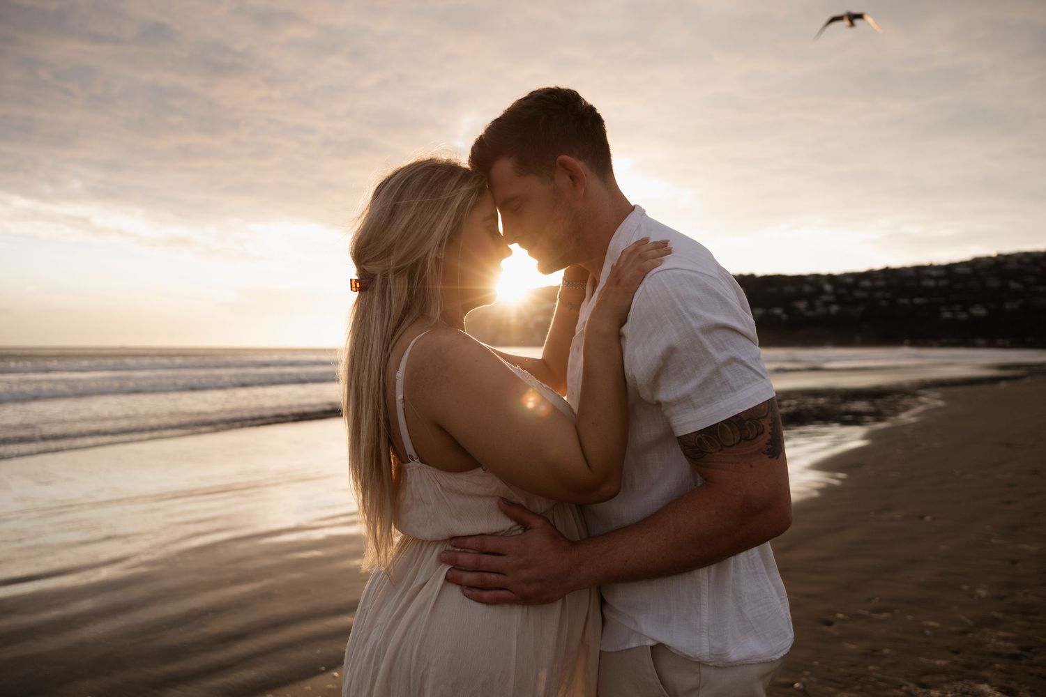 Couples maternity session during sunrise at Sumner Beach