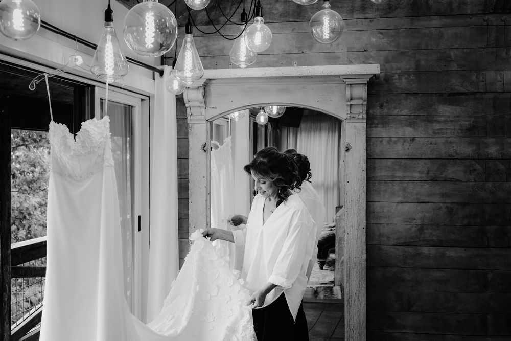 A collection of white wedding dresses hanging on display in various rooms and settings.