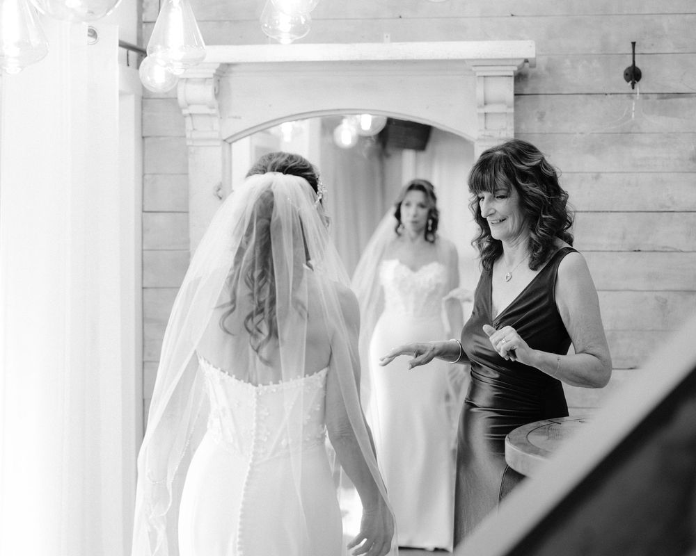 Joyful candid moment captured between people in wedding attire during a celebration.
