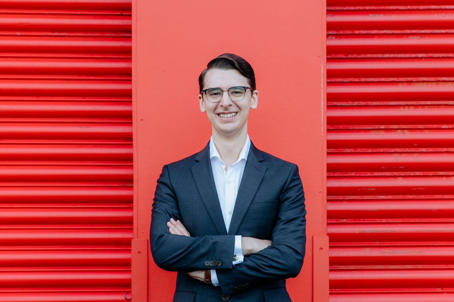 Headshot of Auckland creative professional on colourful backdrop at an outdoor urban location