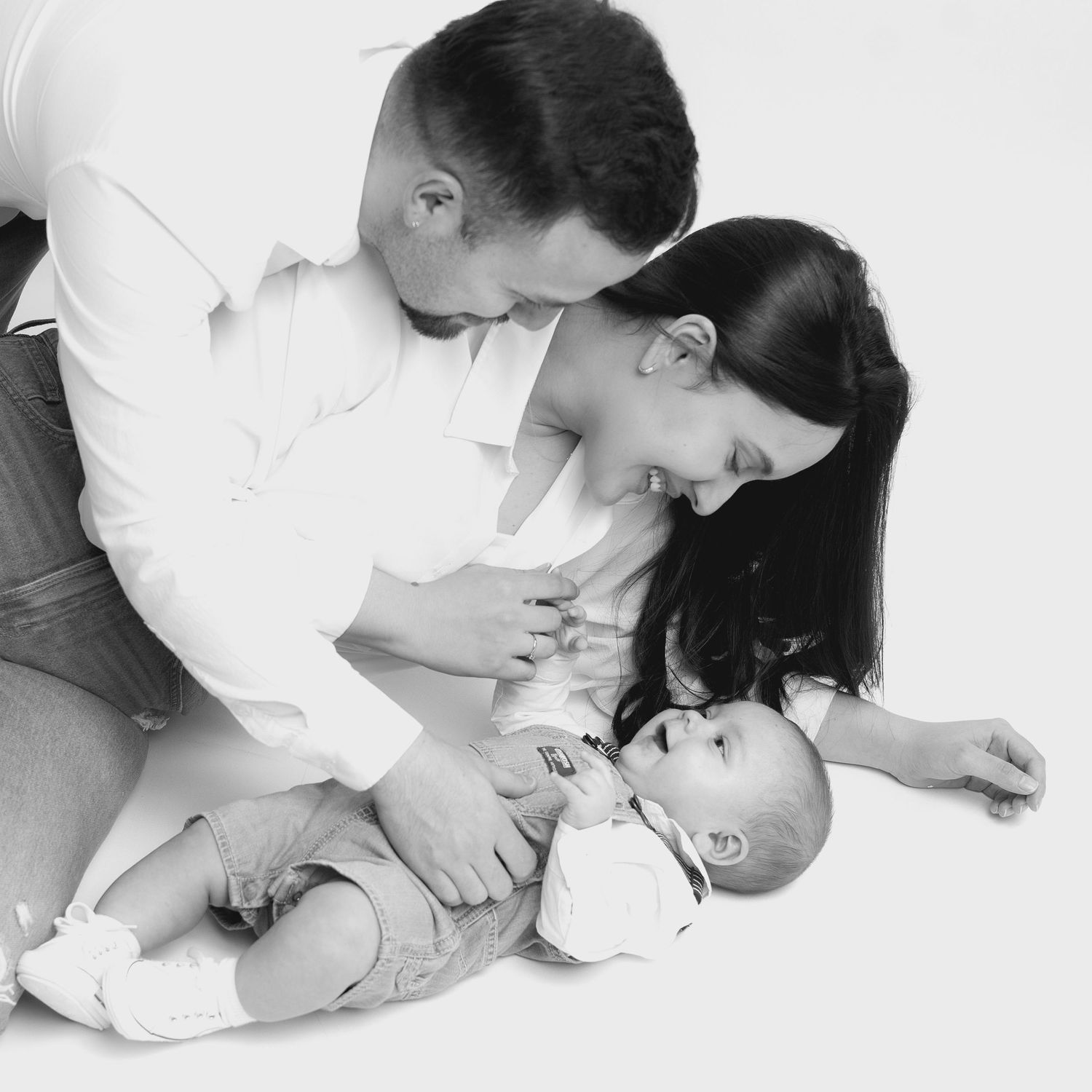 Black and white photo series showing tender moments between parent and child in intimate close-up poses.