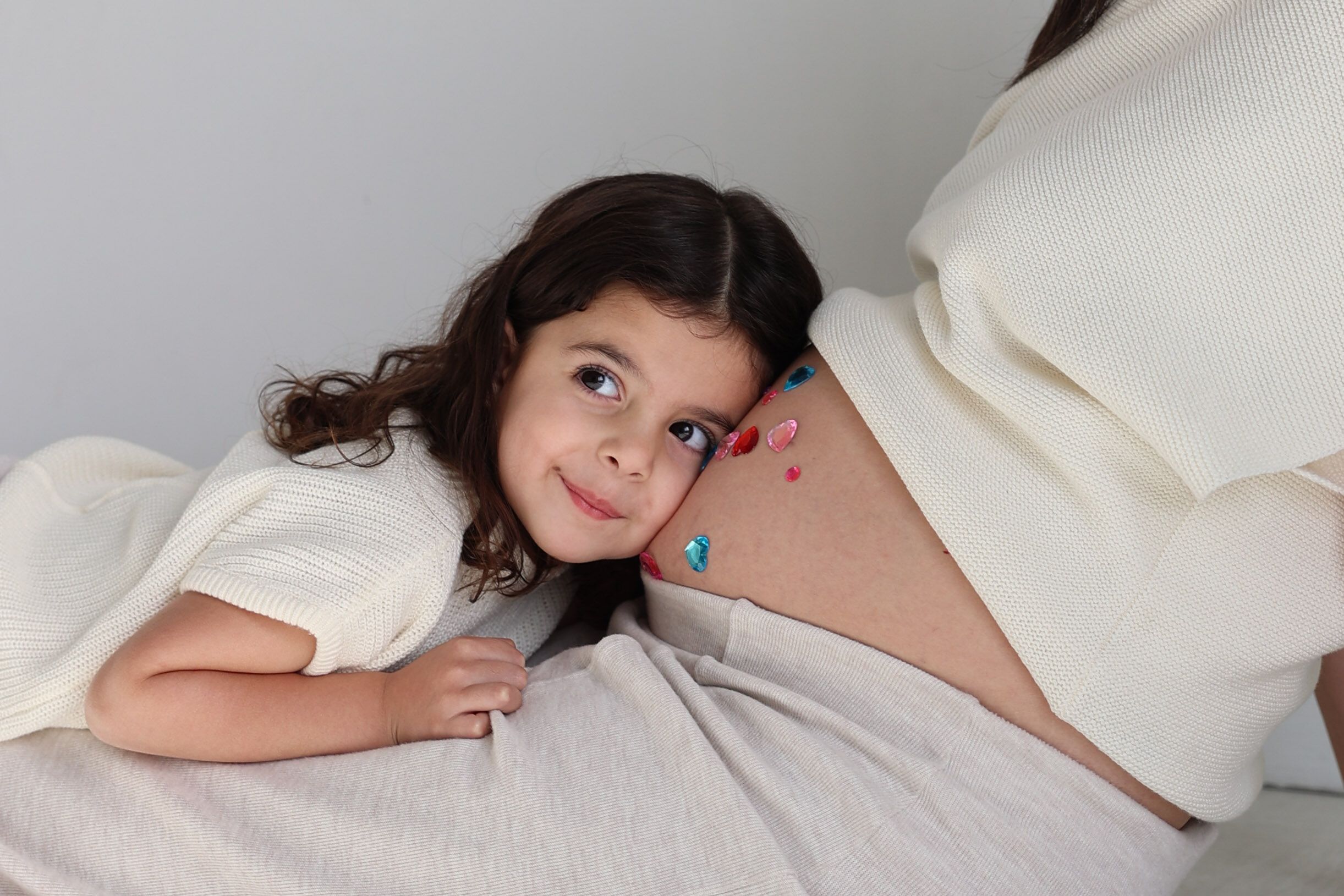 A collection of intimate maternity photos with soft lighting against a white background.