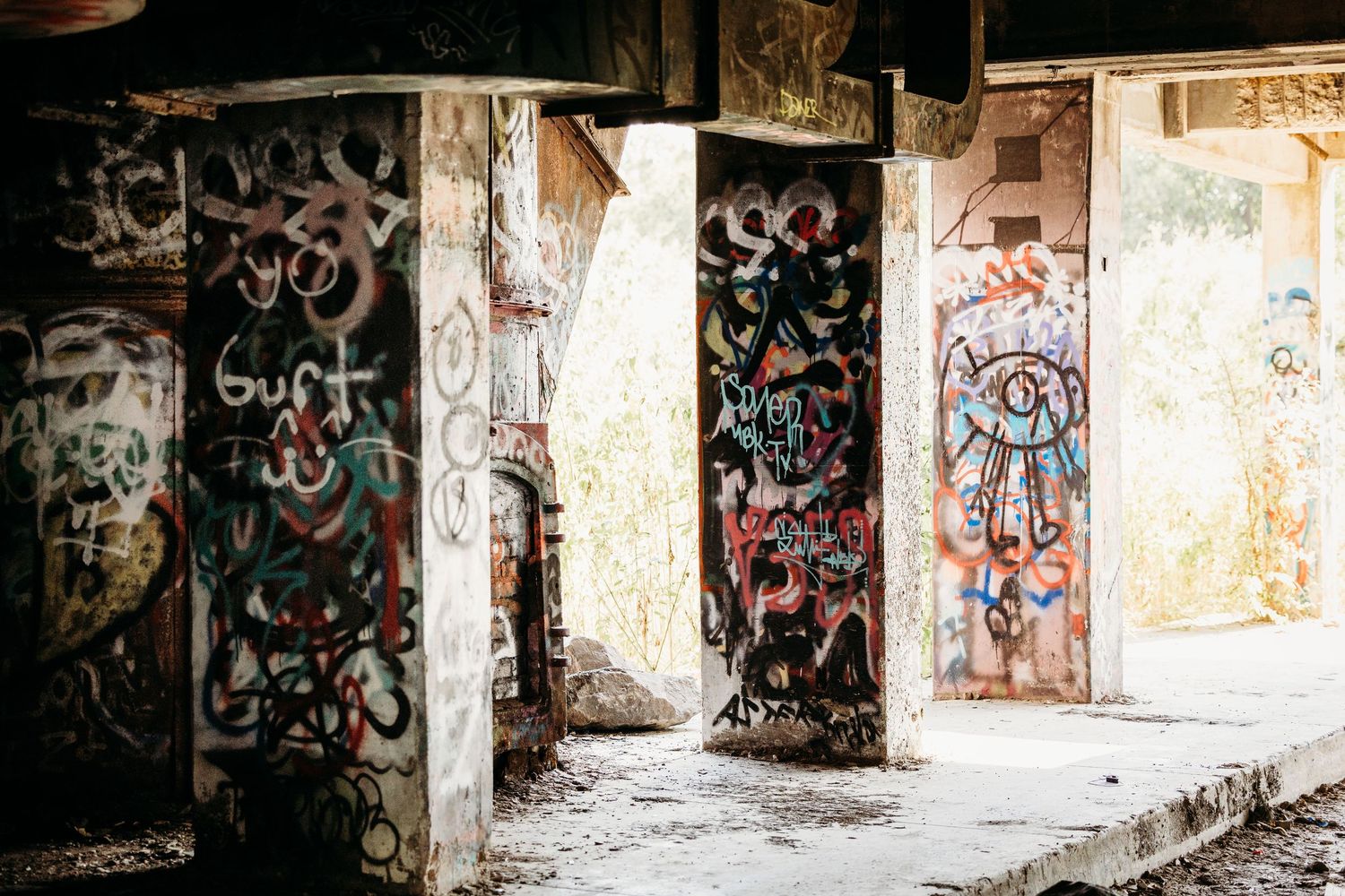 Graffiti covered walls and doorways in an abandoned building with peeling paint and urban decay in Fort Worth, TX.