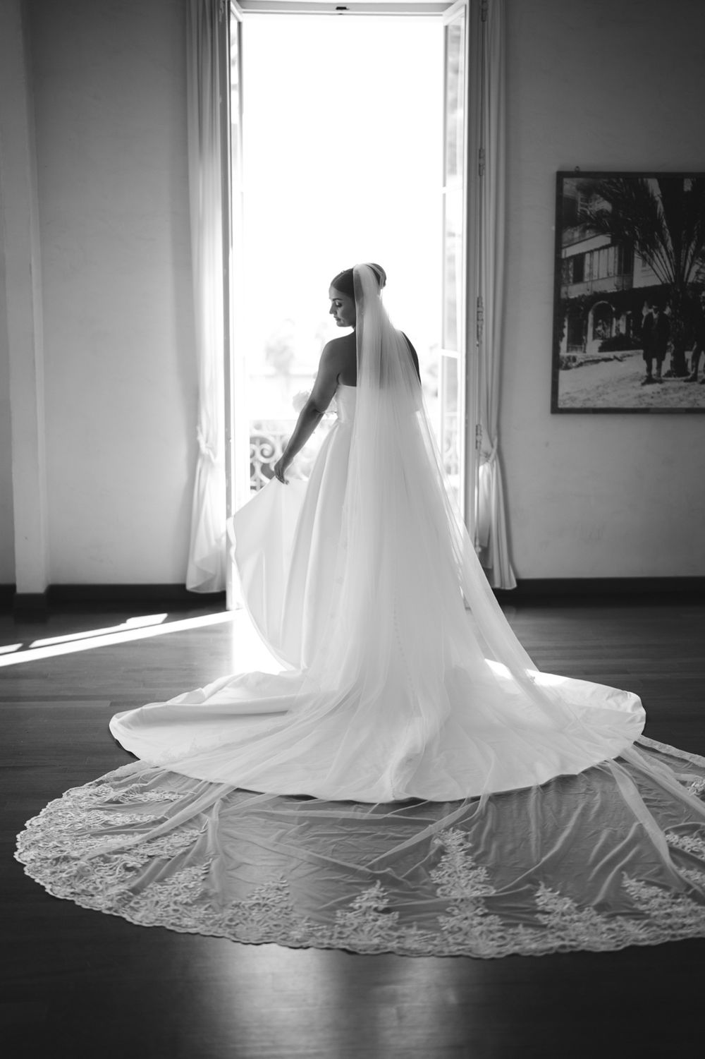 Bride with long veil illuminated by window light at Villa Nobel Sanremo