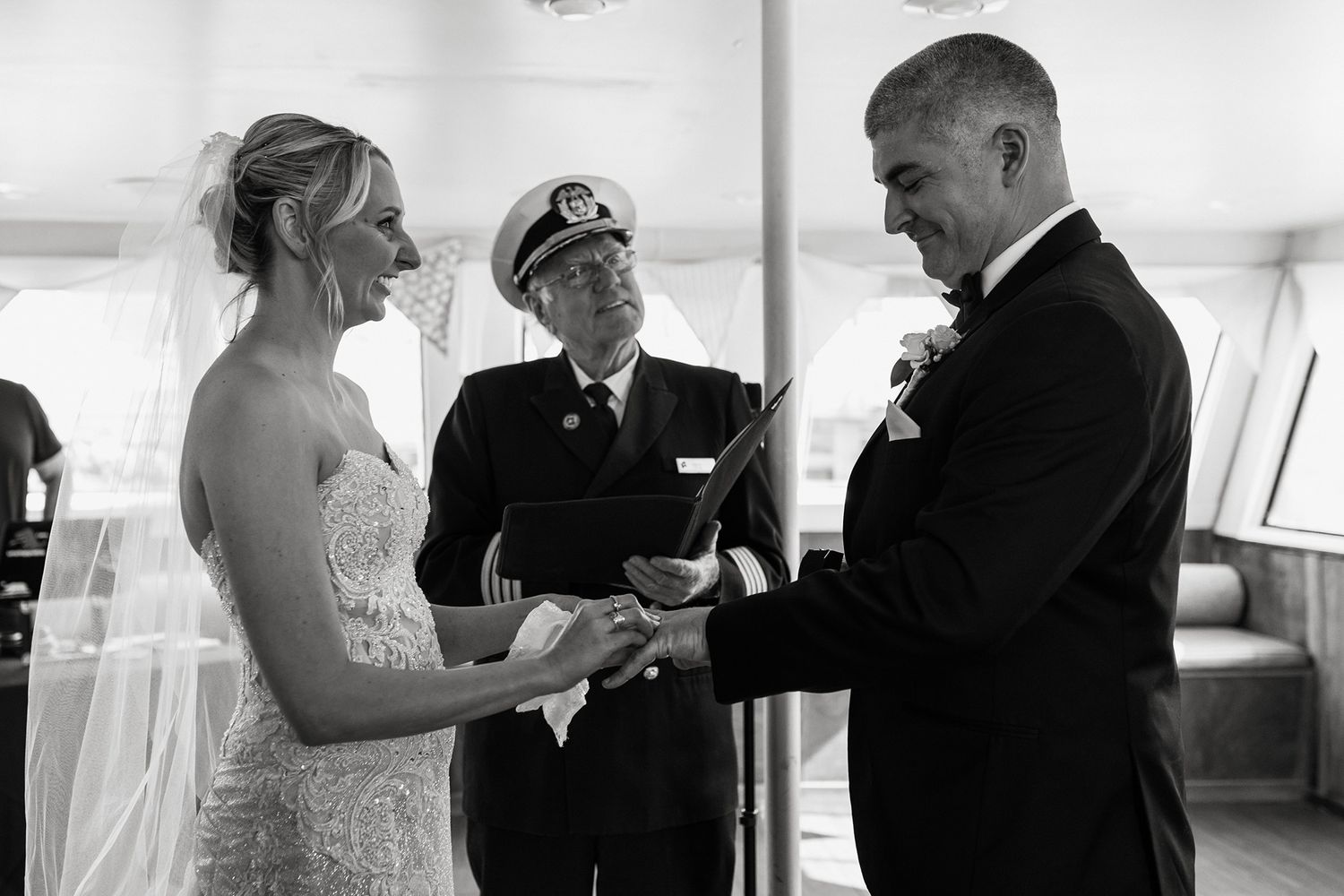 A black and white series of intimate wedding ceremony moments captured on a boat in San Diego.