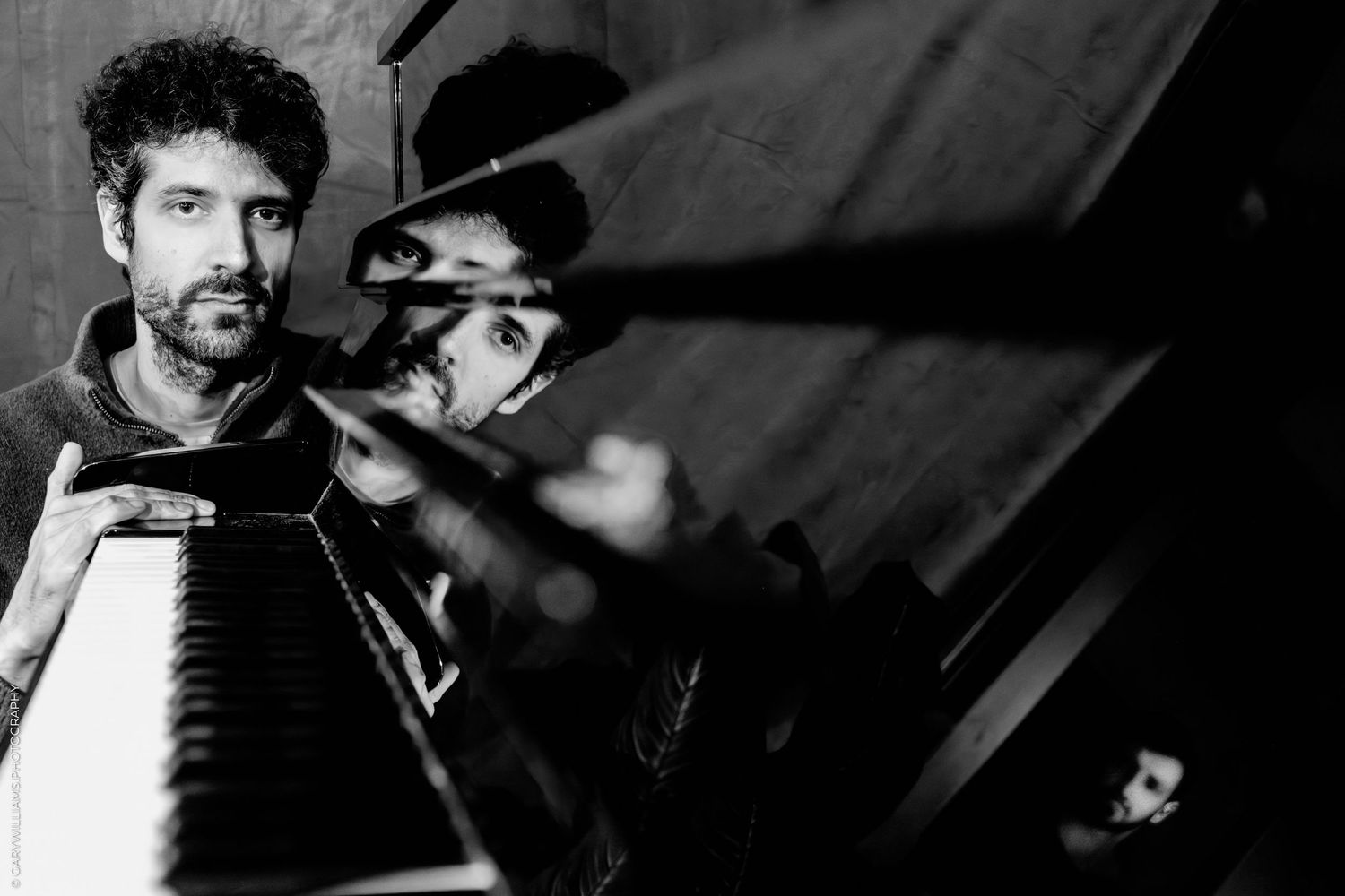 A black and white collage of vintage-style photographs showing musicians performing with string instruments.