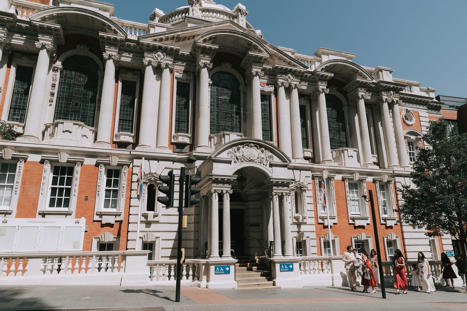 Woolwich Town Hall Grand neoclassical building with tall columns and ornate facade on a sunny London street.