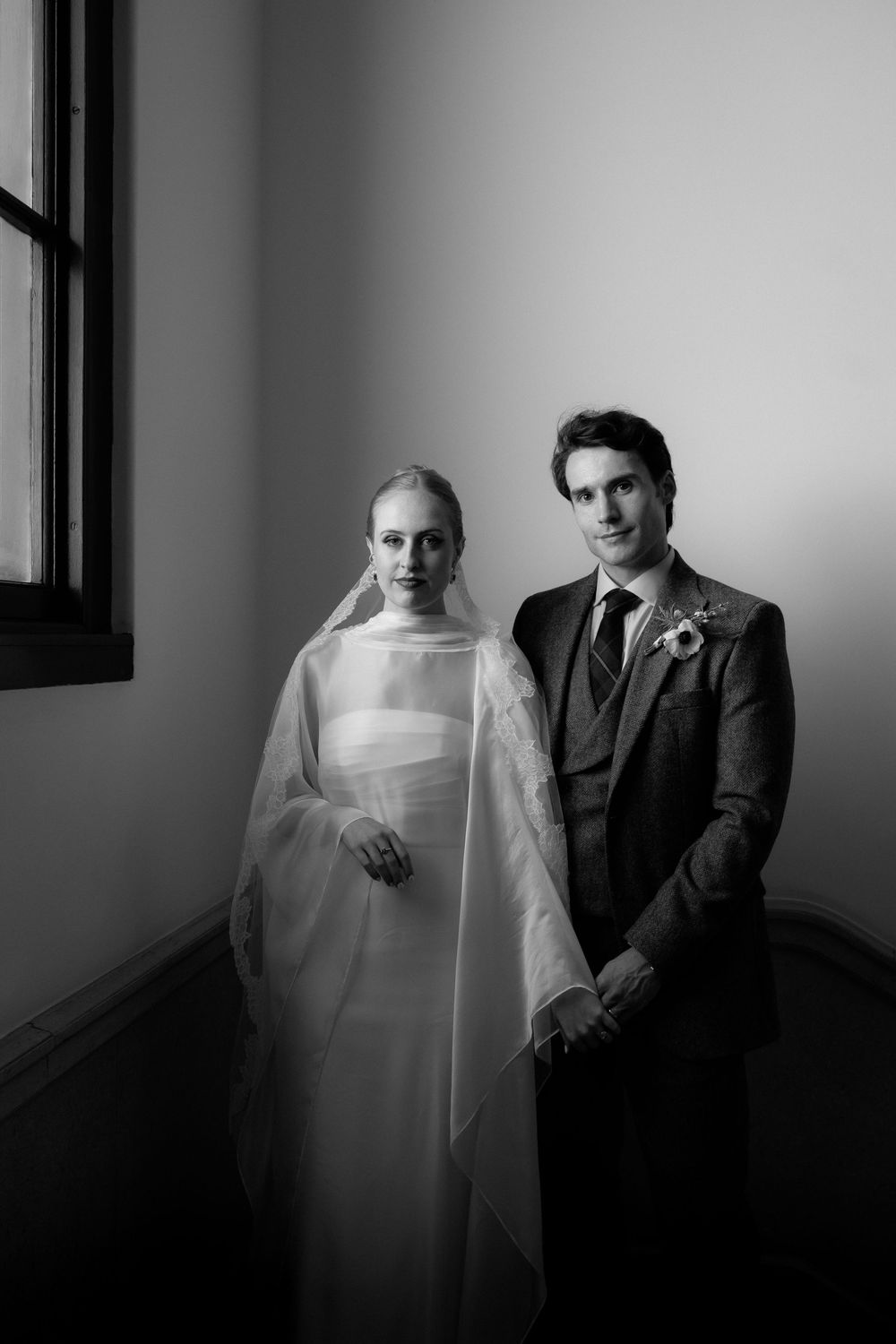 Black and white artistic photo series showing a ghostly figure in white veil next to someone in dark suit.