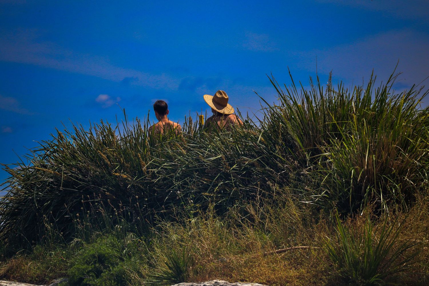 Father and son sitting at Milk Beach