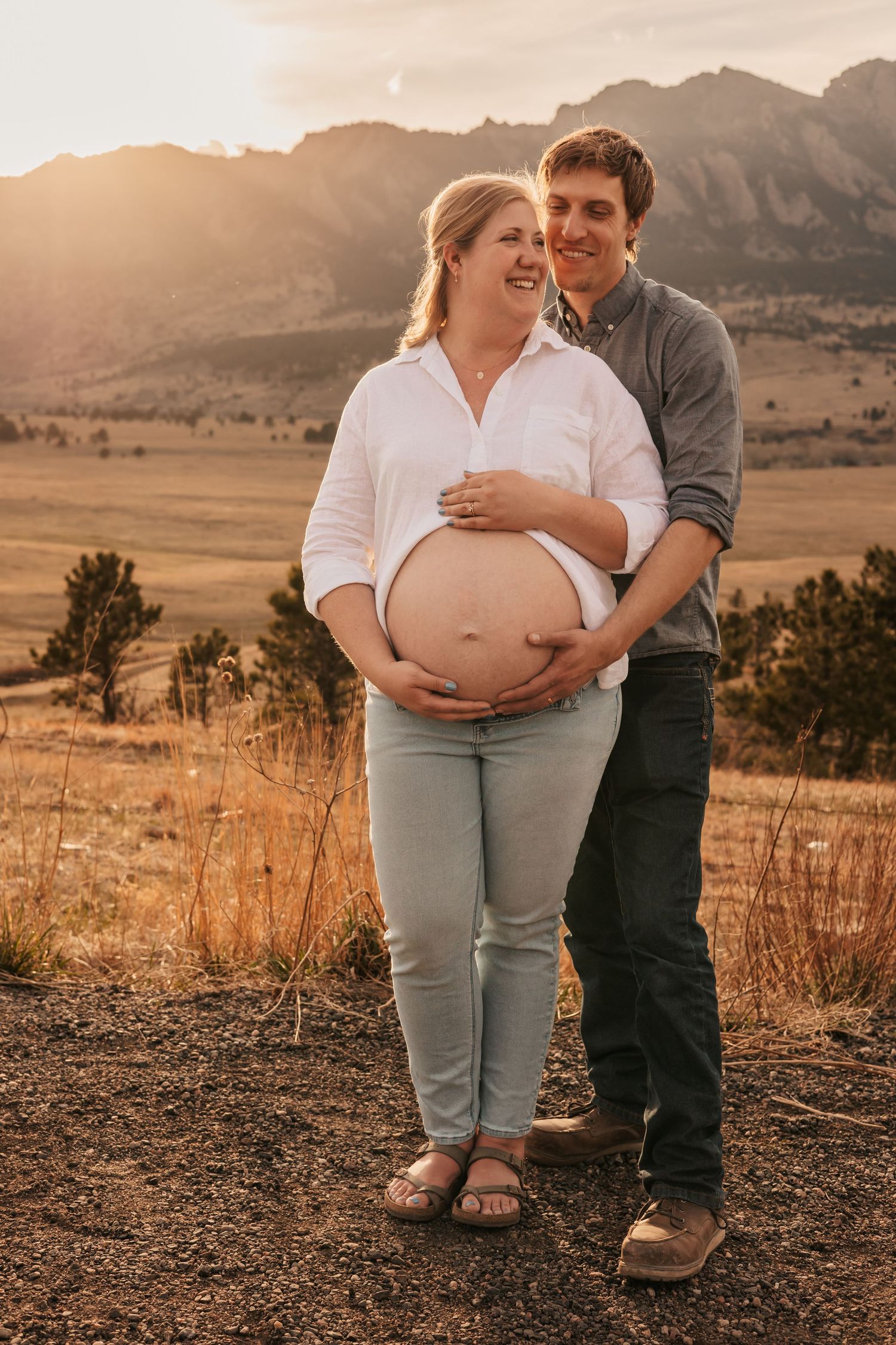 Pregnant couple embracing at golden hour showing baby bump | Maternity Photos in Boulder Colorado