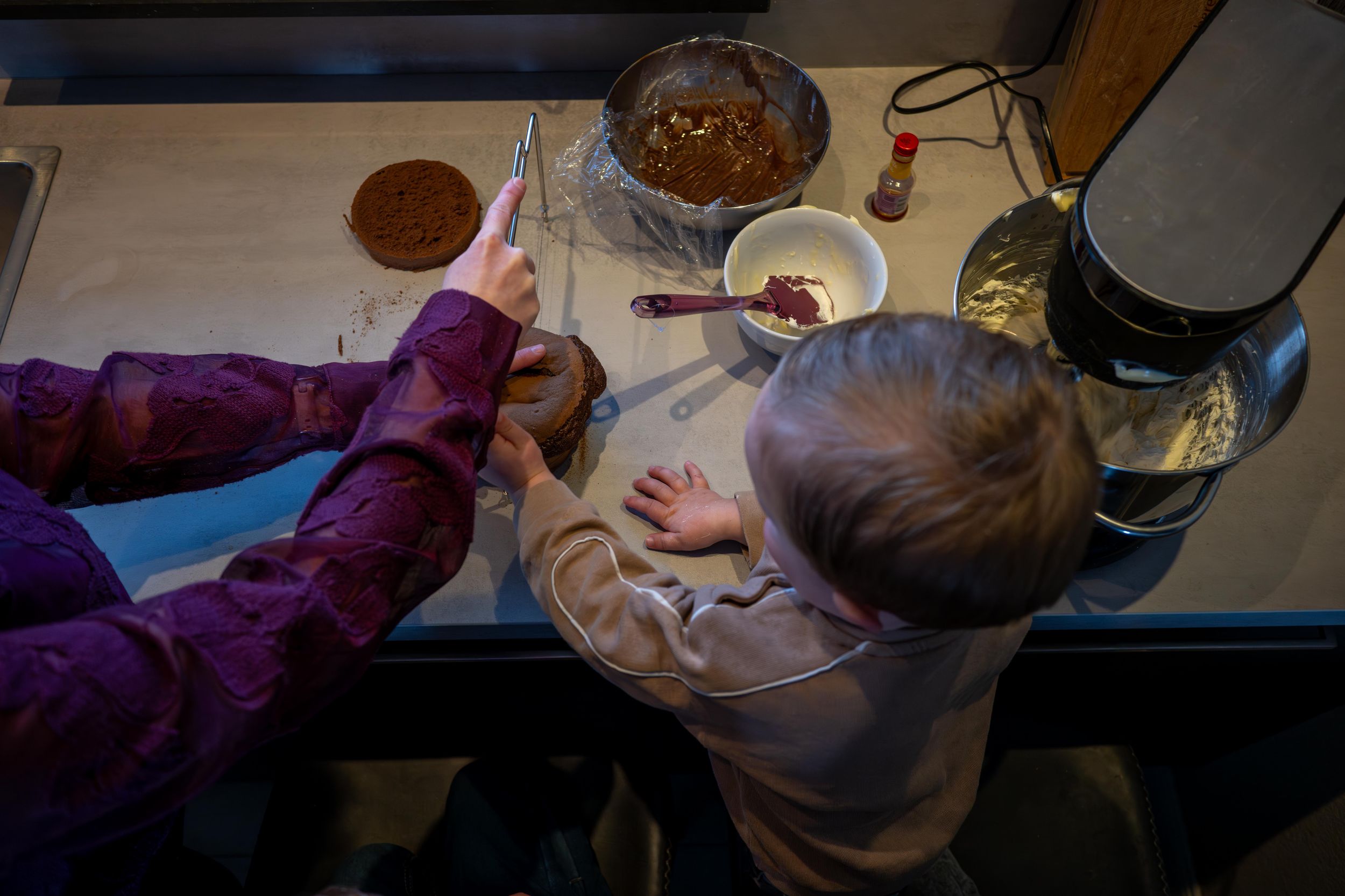 Overhead view of someone eating at a table with various dishes and plates visible.