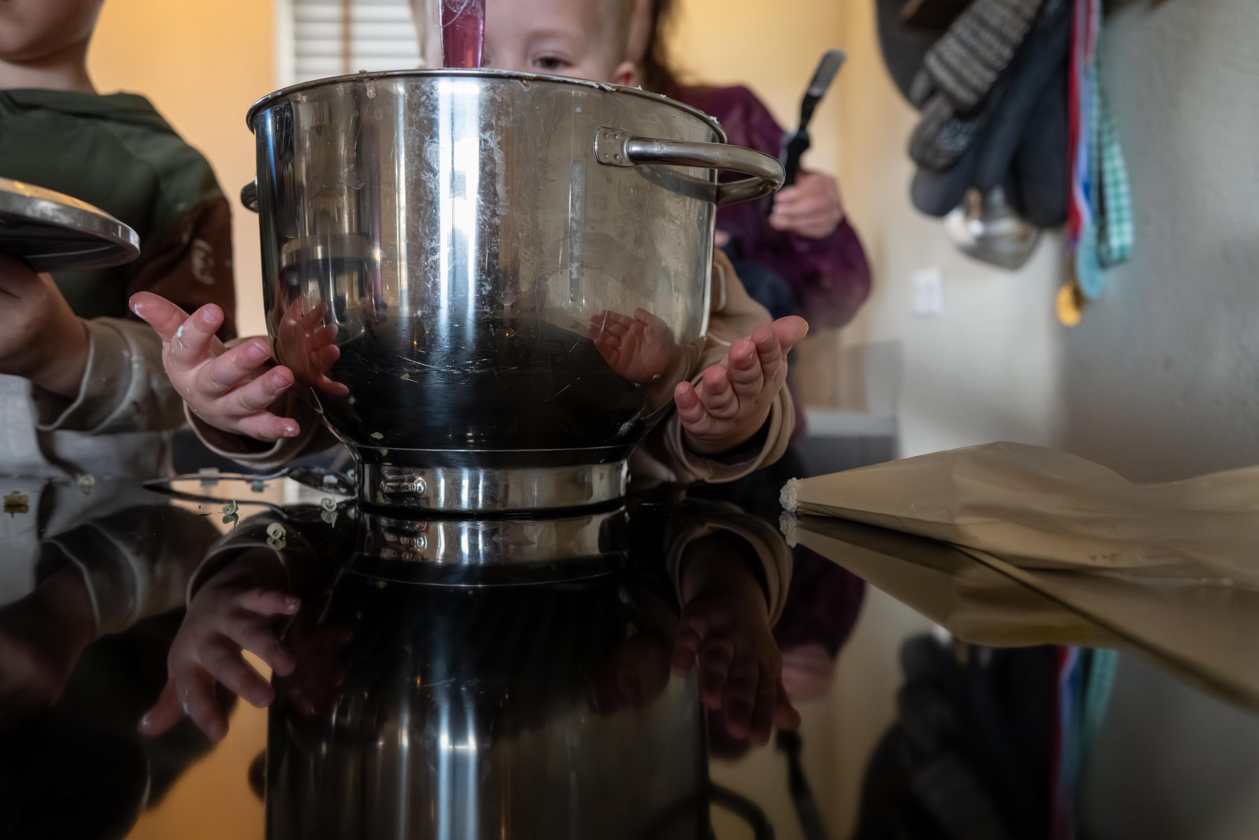 A person pours hot water in a circular motion over coffee grounds in a filter cone during the brewing process.