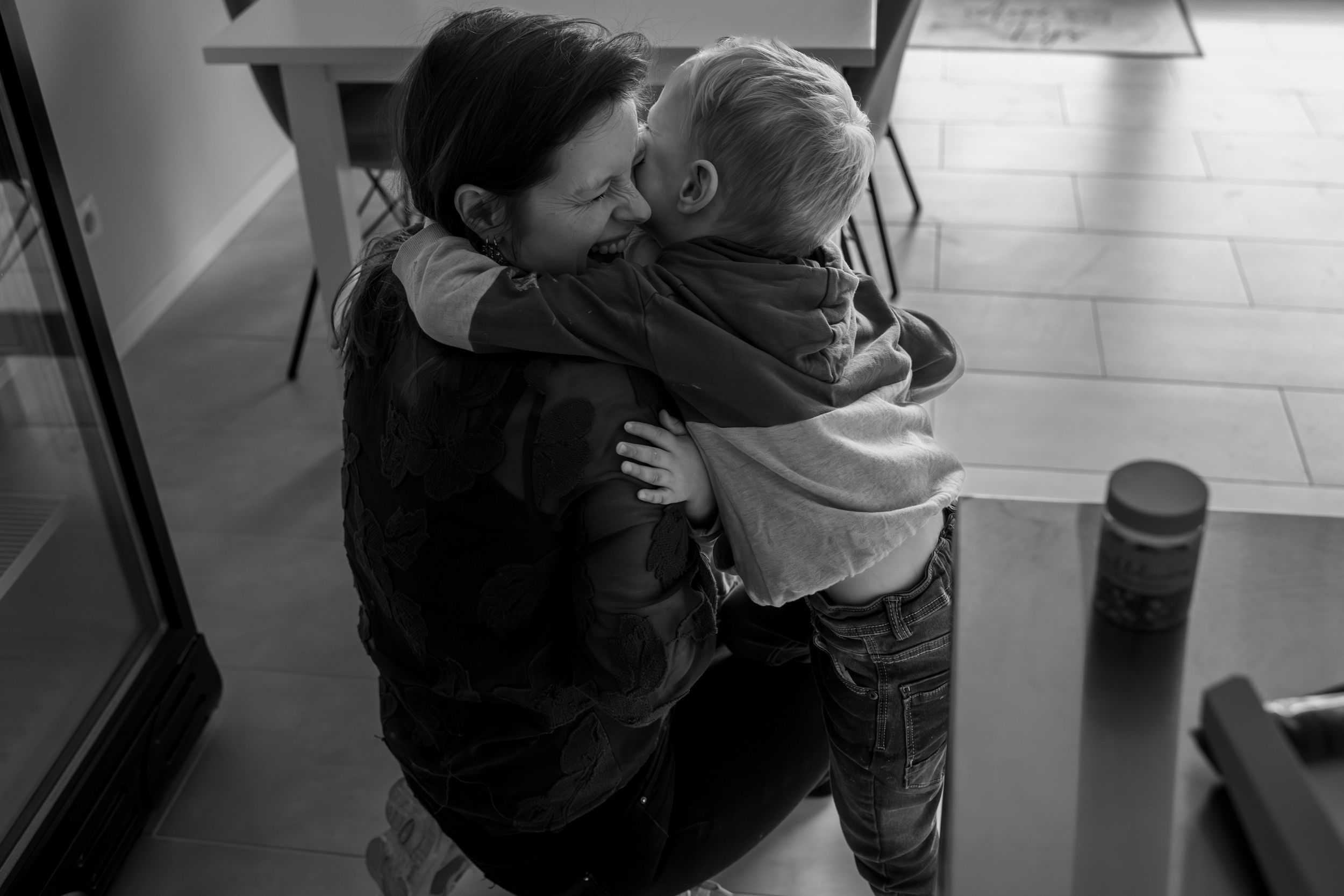 A sequence of five black and white photos showing a couple embracing in what appears to be a train station.