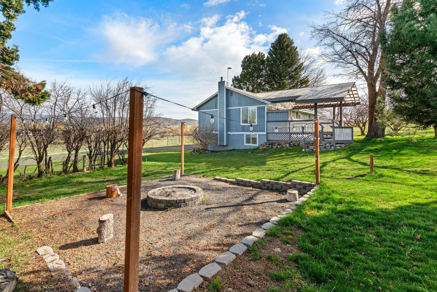 Spacious backyard with landscaped walkway and outdoor space in Ellensburg, WA real estate listing.