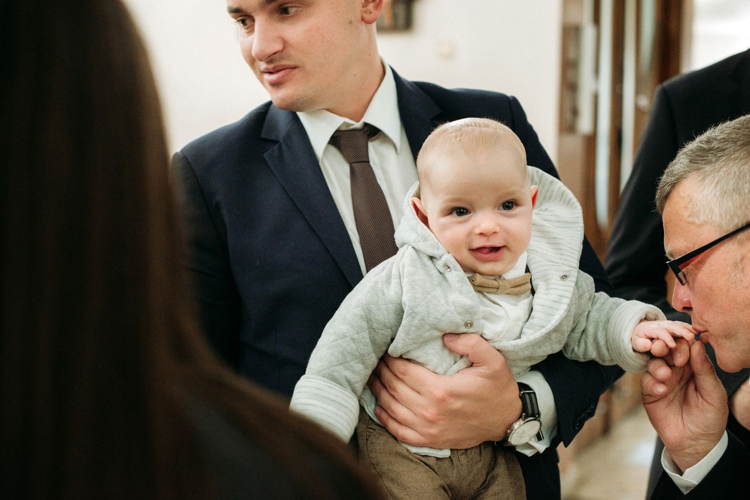 Casual family moments captured as loved ones share smiles and laughter during an indoor gathering.