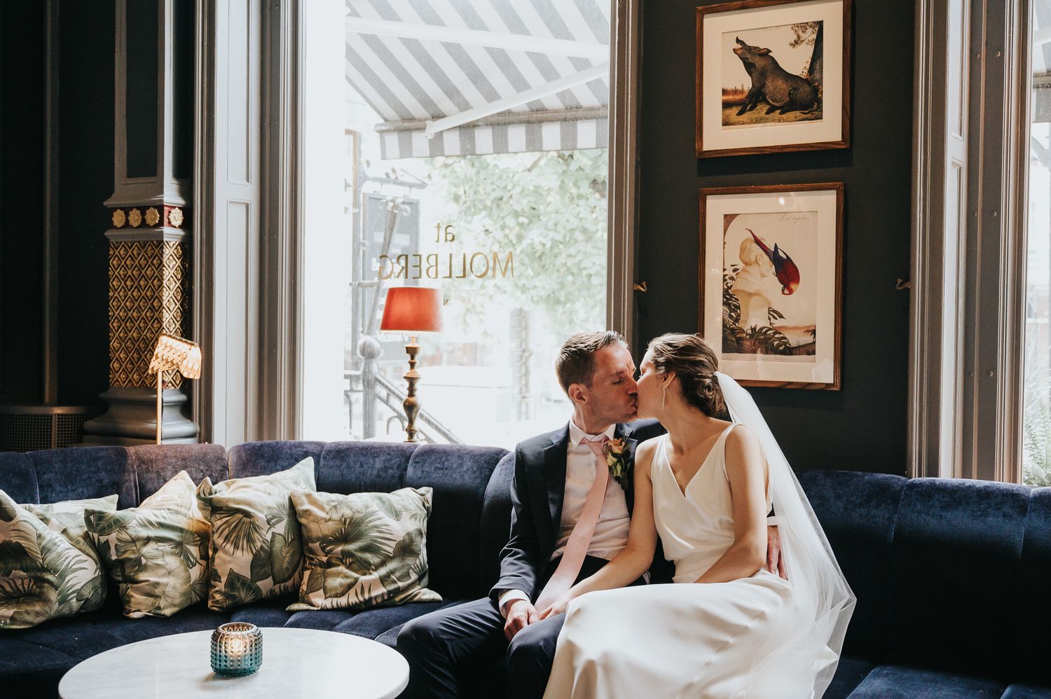 A series of wedding photos showing romantic moments between a couple in a vintage-style indoor setting.