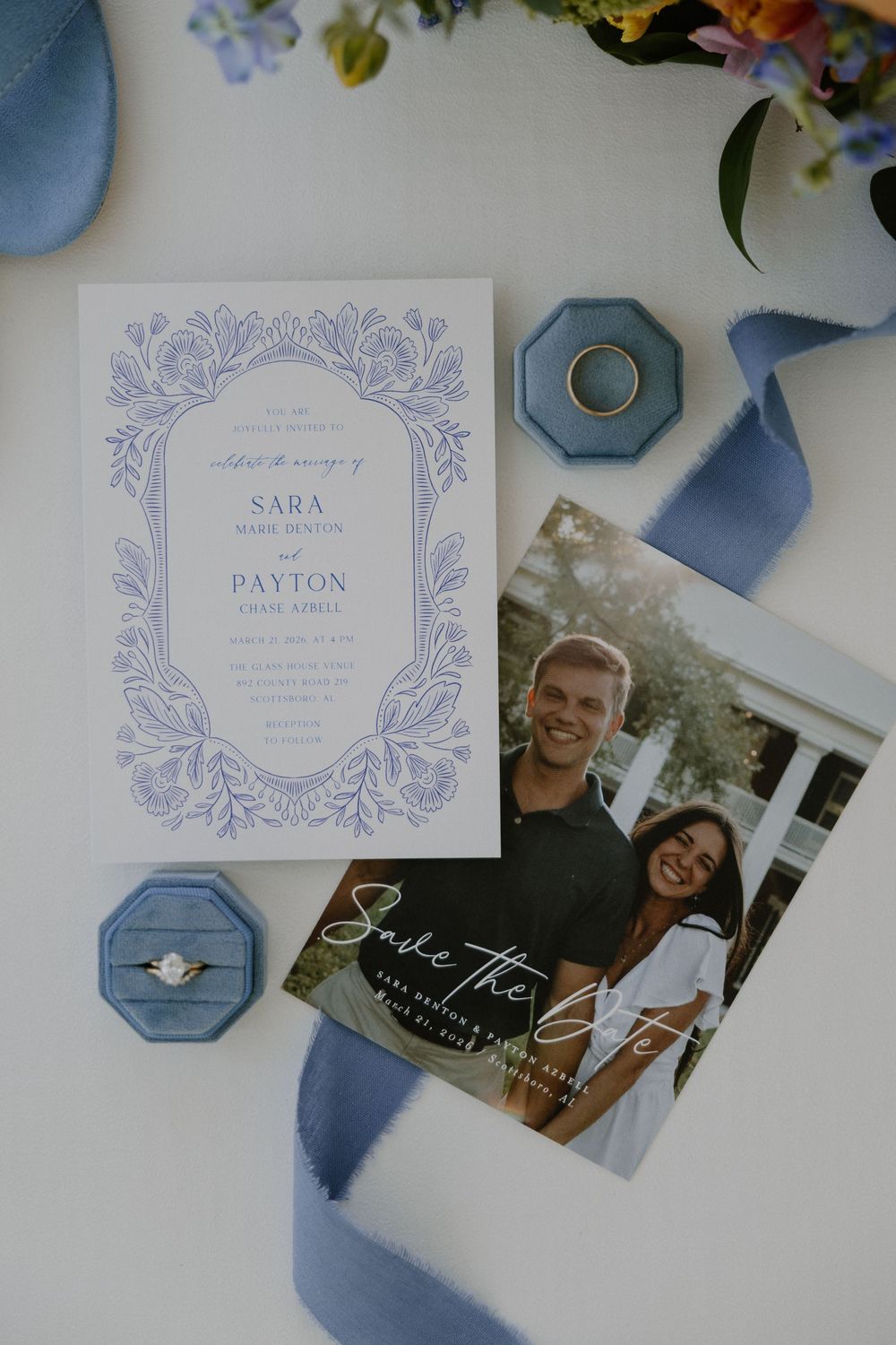 Wedding invitations and details in soft blue tones with floral designs and photographs.