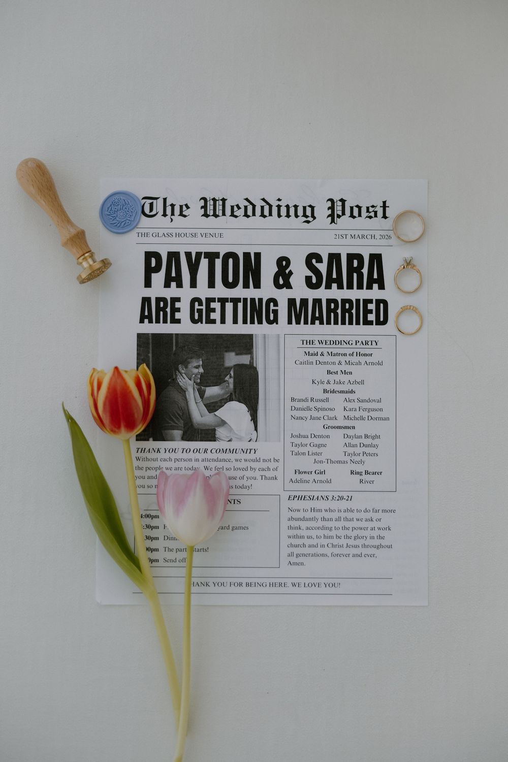 A creative newspaper-style wedding announcement with tulips and vintage styling.